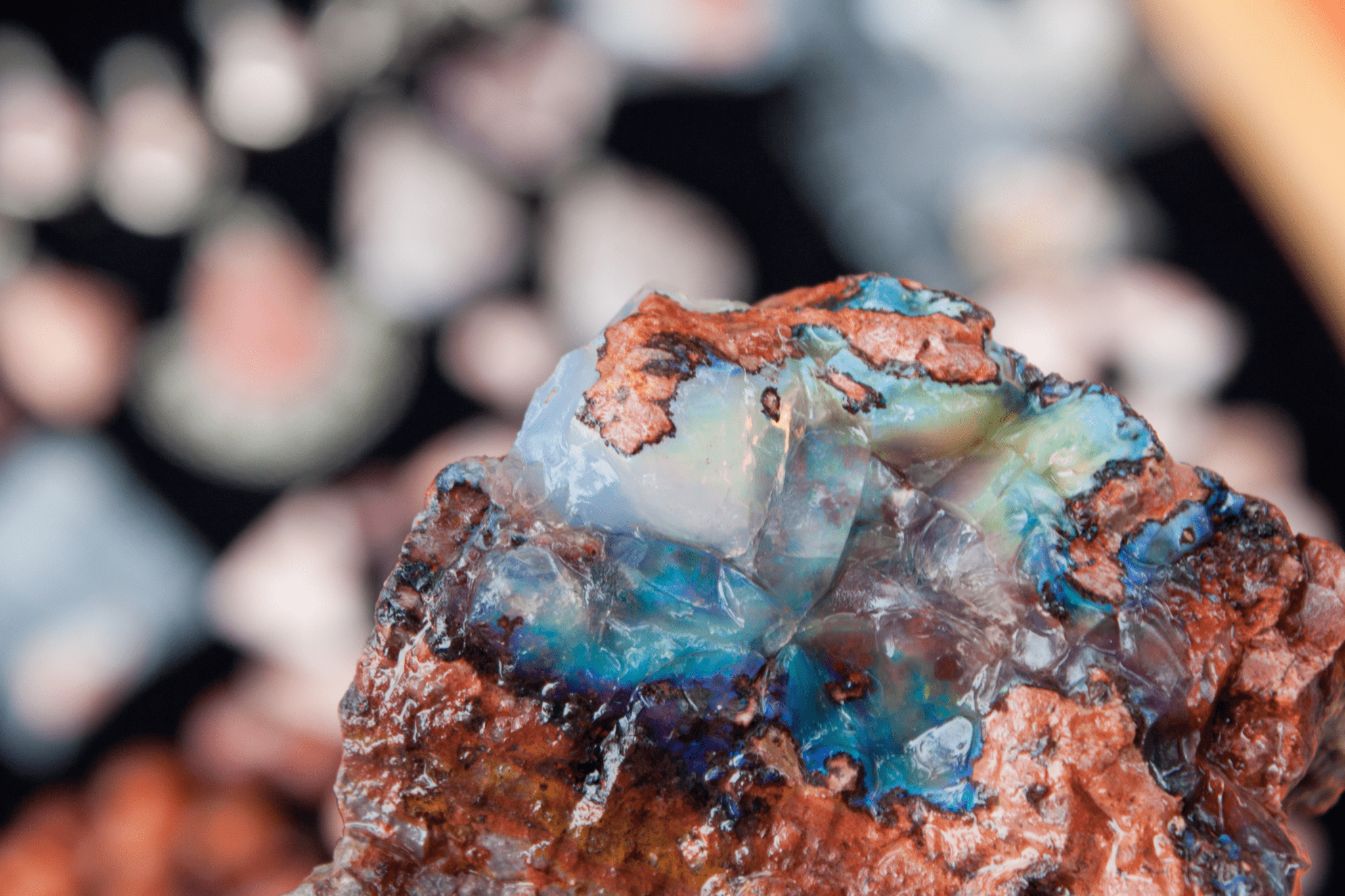 A boulder opal rock showing the opal stone set into ironstone matrix