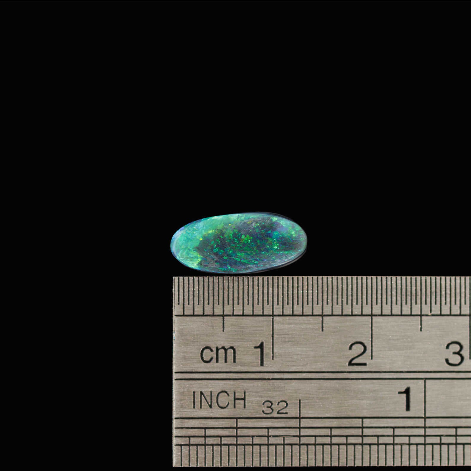 Rare Australian black opal gemstone with vivid green fire and classic oval cut
