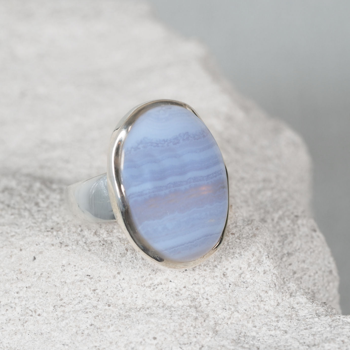 The ‘Vivianne’ silver ring with an oval Blue Lace Agate cabochon showing gentle blue banded patterns