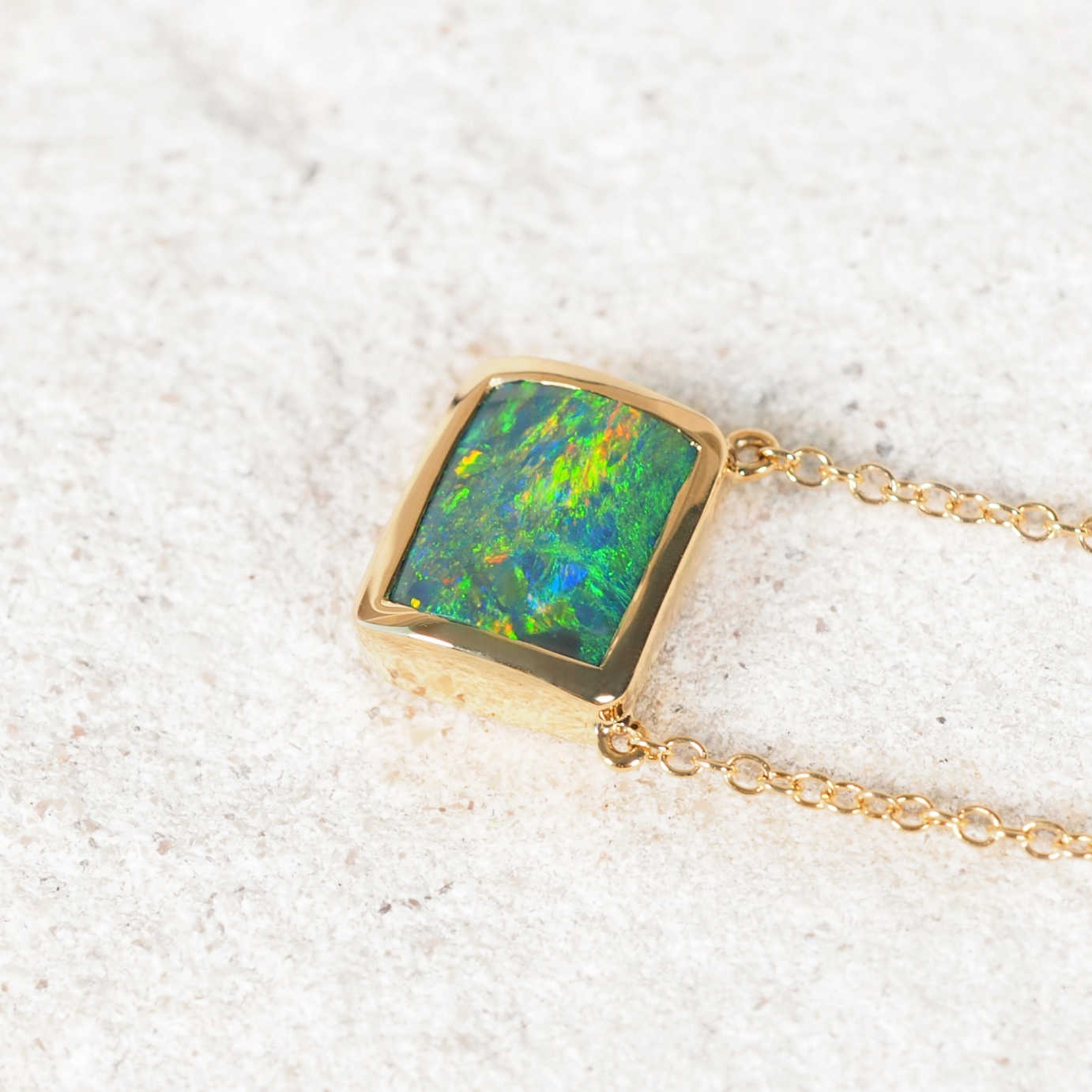 Elegant Emmella black opal necklace handcrafted in 14ct yellow gold with vivid multi-coloured Lightning Ridge opal