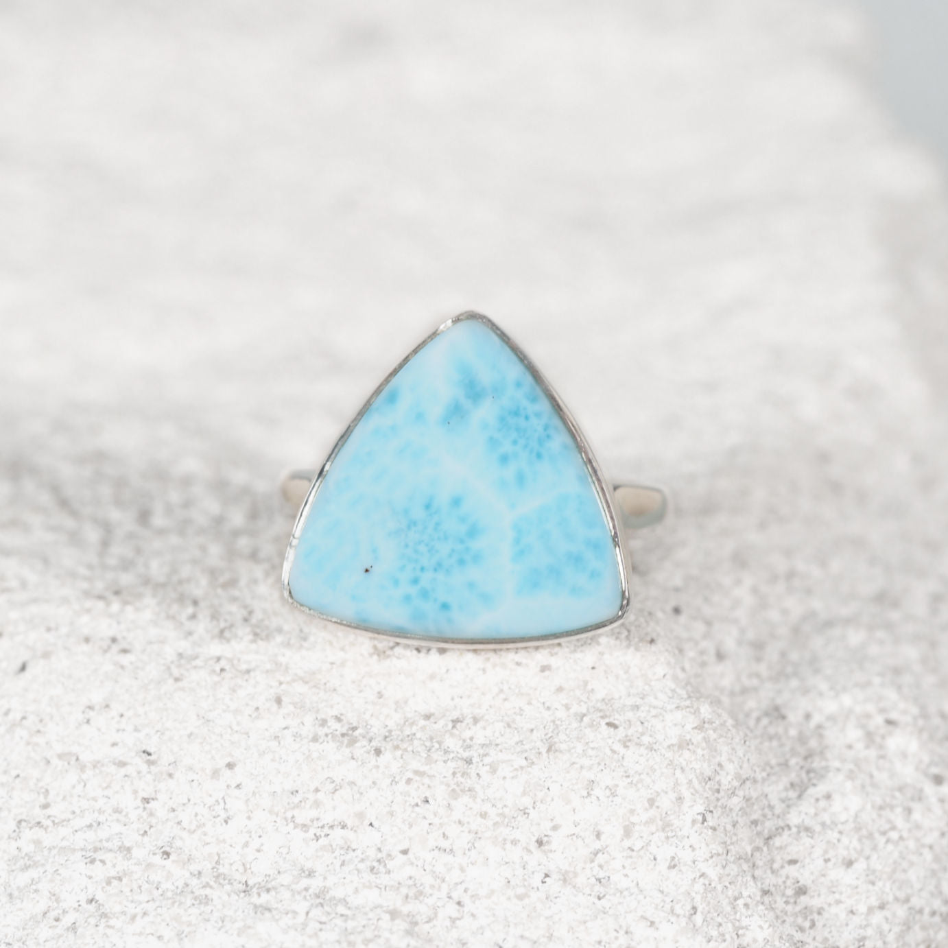 Elegant silver ring, ‘Xanthe,’ featuring a smooth triangular Larimar cabochon with natural colour variations