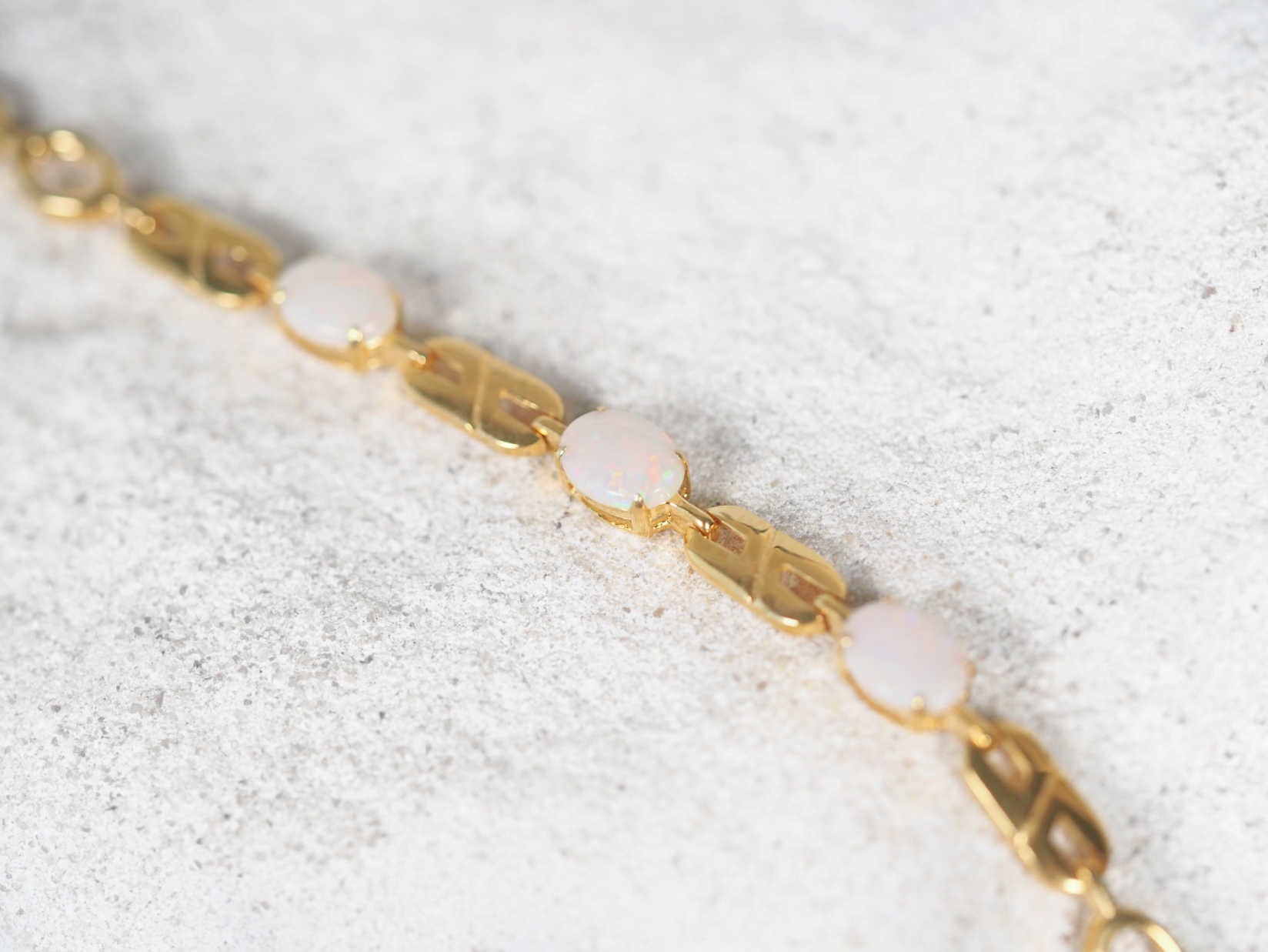 Claw set opal bracelet in gold plated silver with South Australian white opals