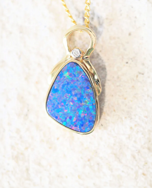 A gold opal pendant featuring a blue speckled Australian opal