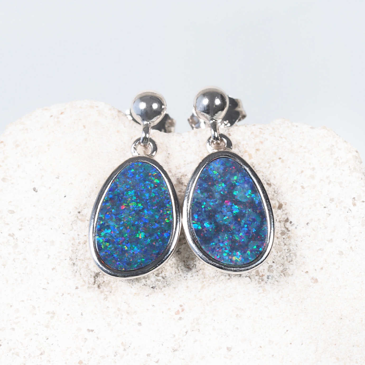 Multi-coloured Australian doublet opals with pinfire pattern in bezel settings