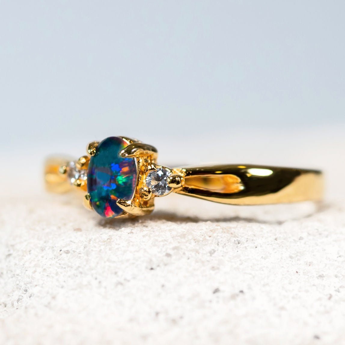 close up of an opal ring set in gold plated silver
