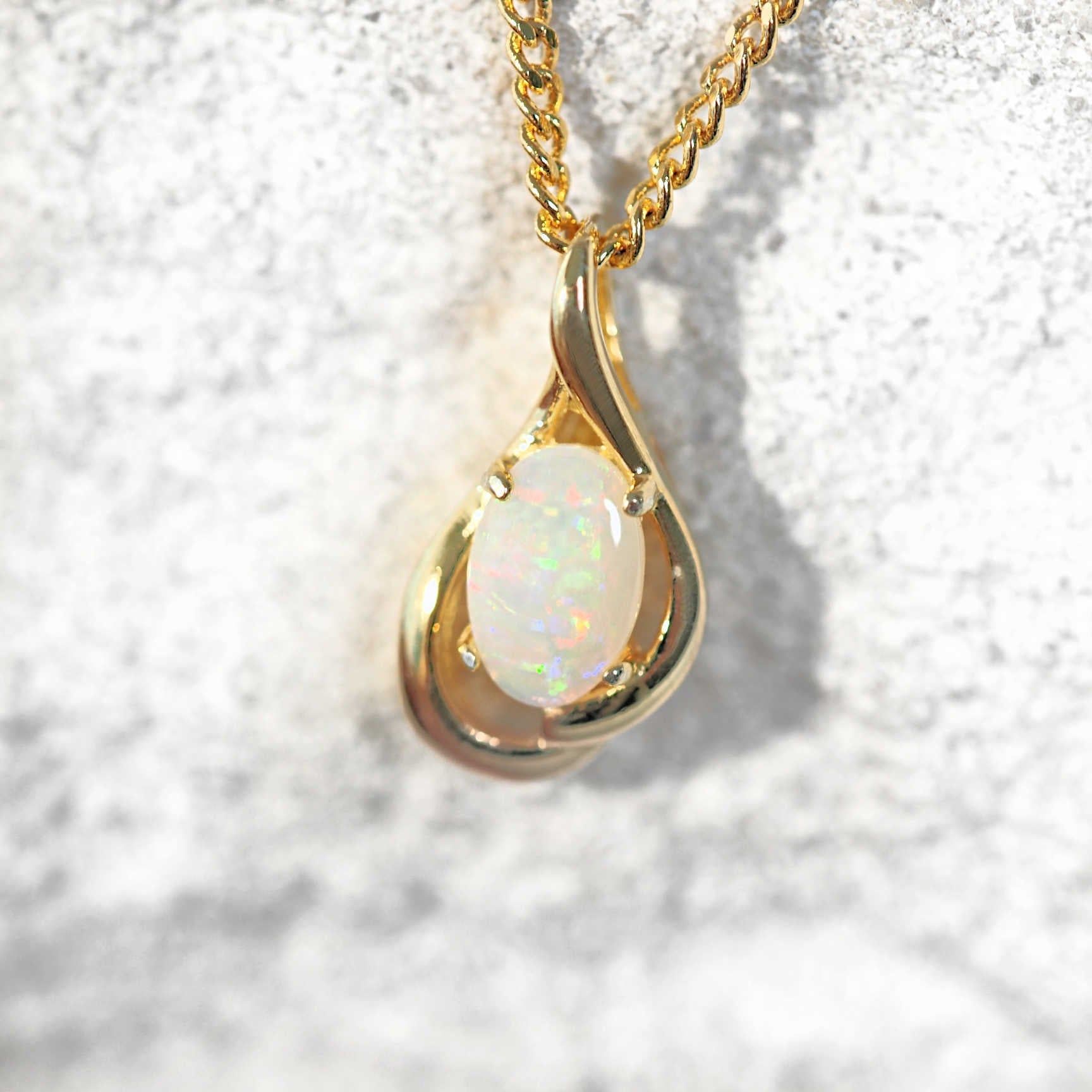Crystal opal pendant set in gold plated silver