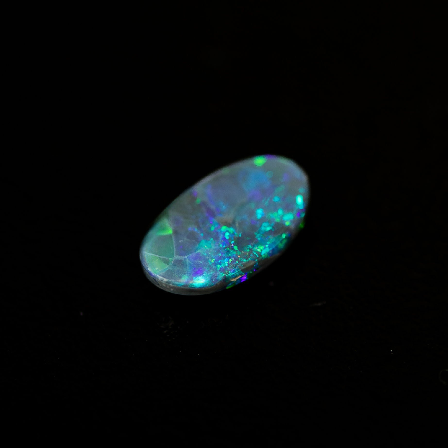 Natural Australian black opal with sparkling green speckle pattern