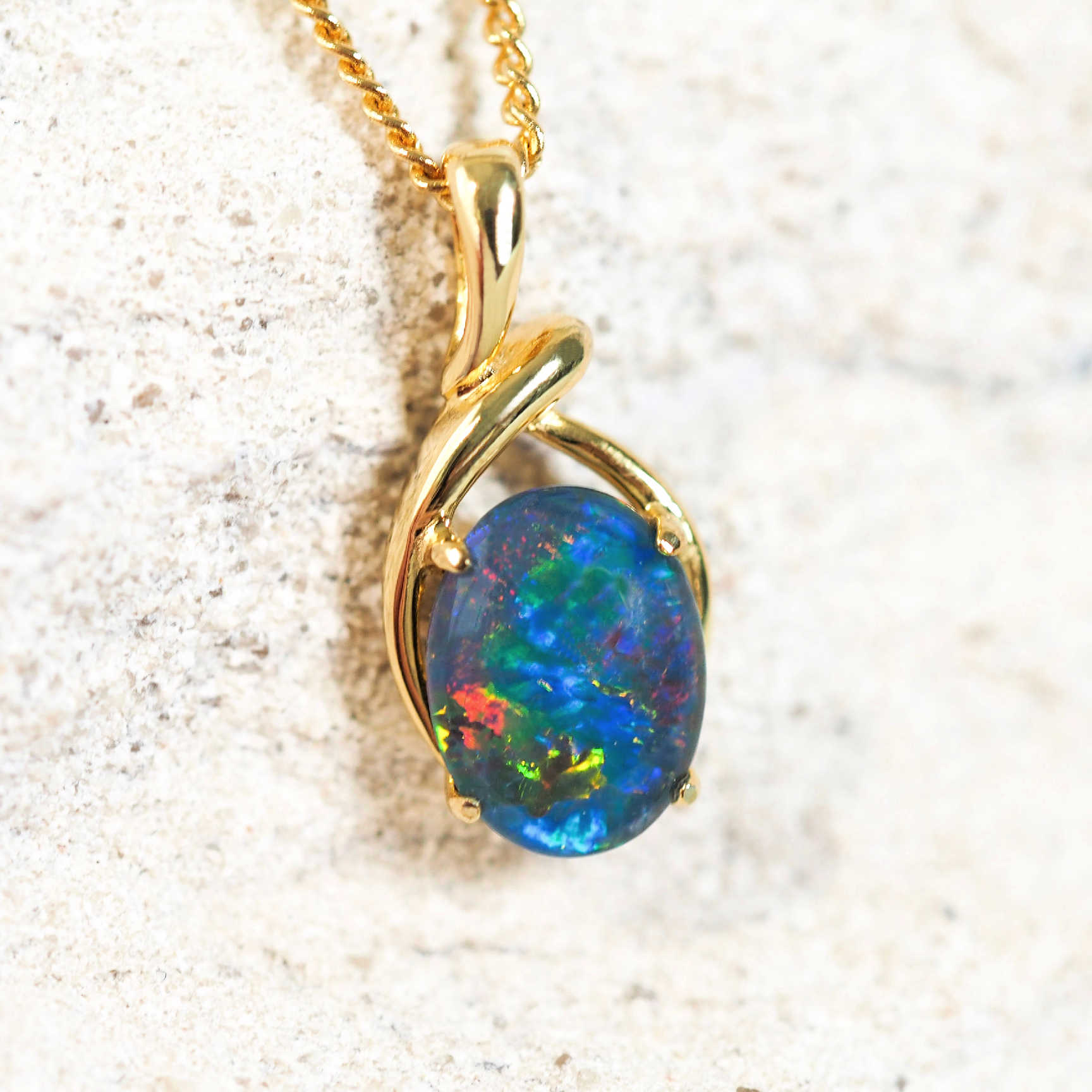 colourful australian triplet opal set into a gold plated silver pendant setting