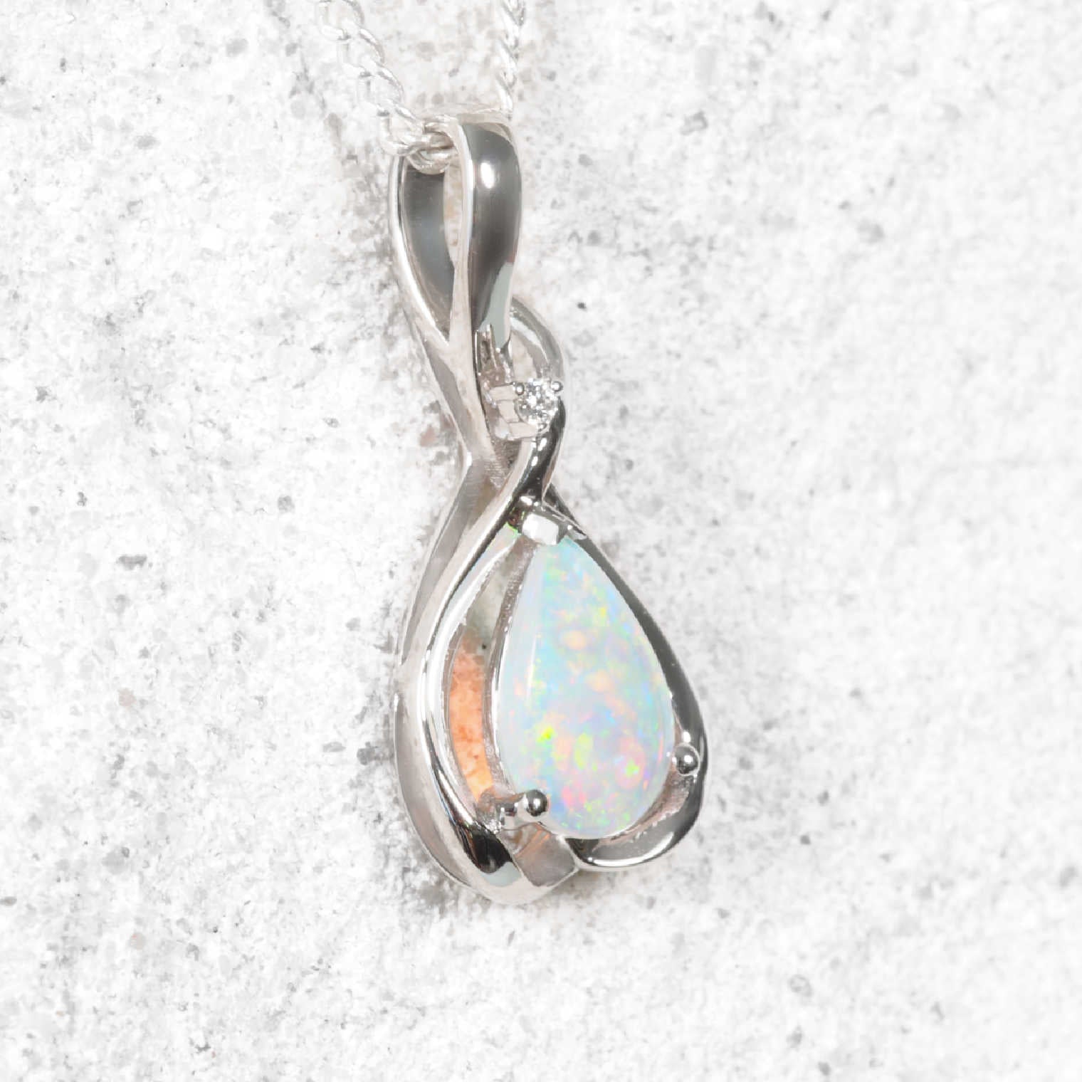 White gold opal pendant with a teardrop-shaped opal stone