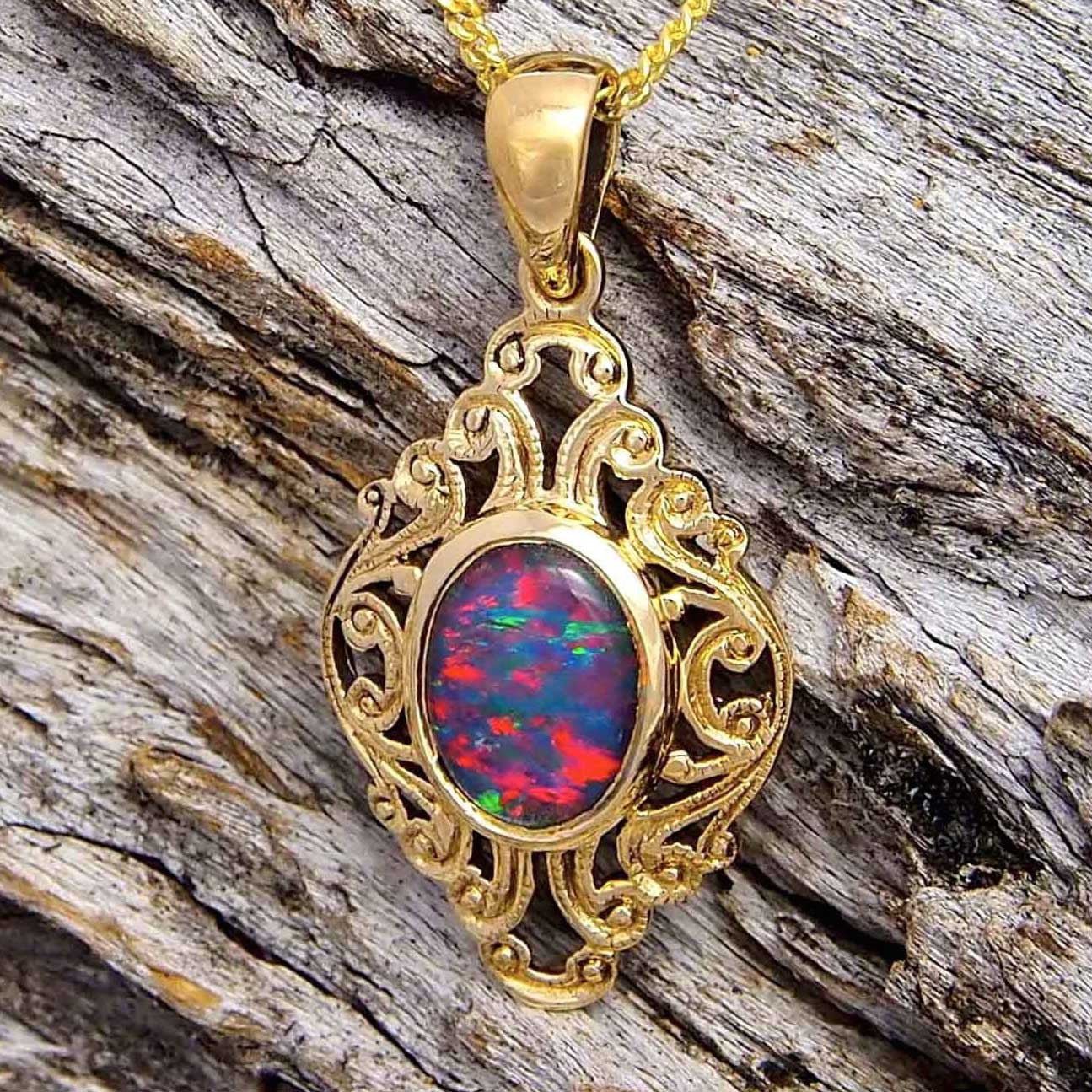 9ct yellow gold decorative design necklace pendant bezel set with a rich blue, red and green oval triplet opal