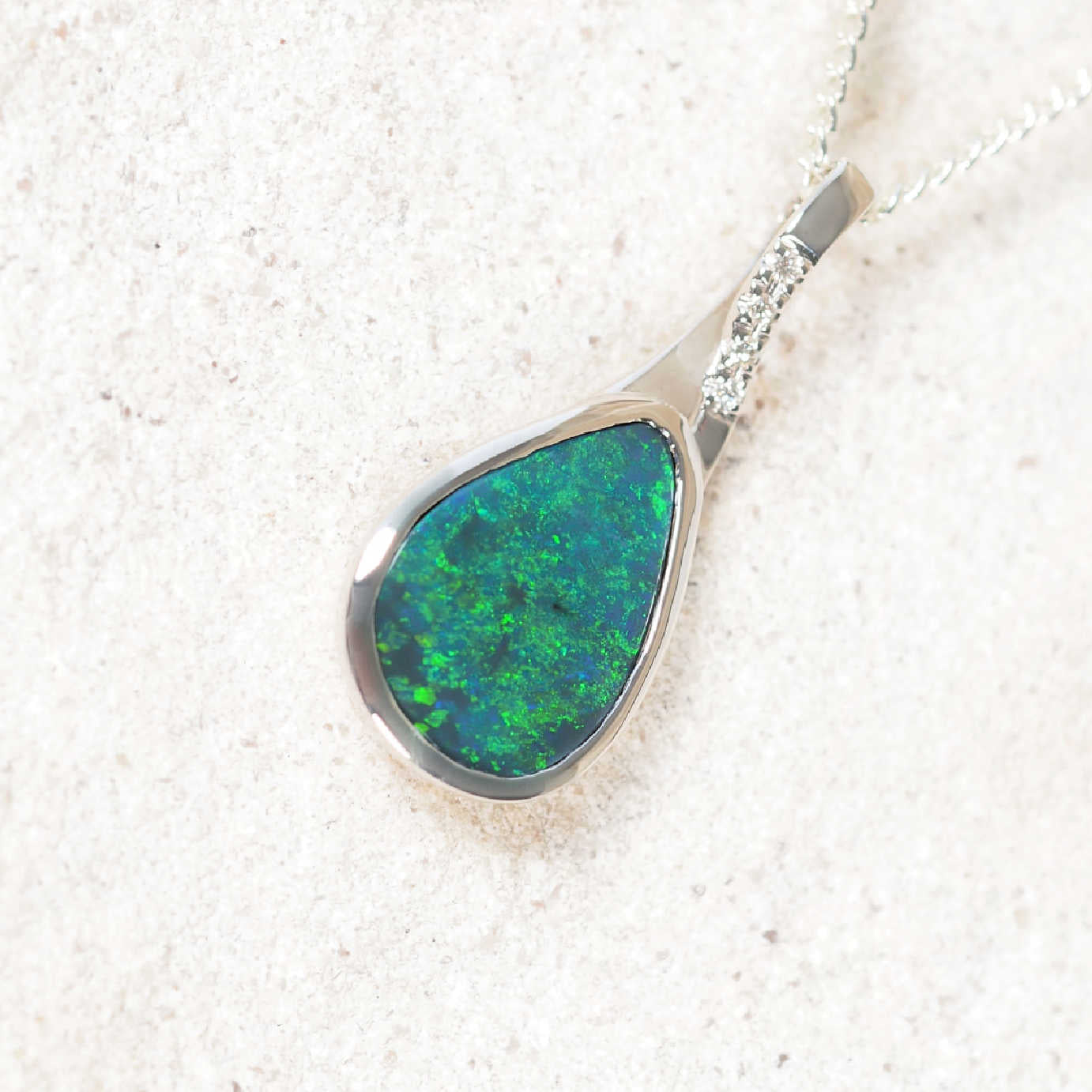 Luxury Australian black opal pendant featuring bezel-set teardrop solid opal from Lightning Ridge with diamond accents