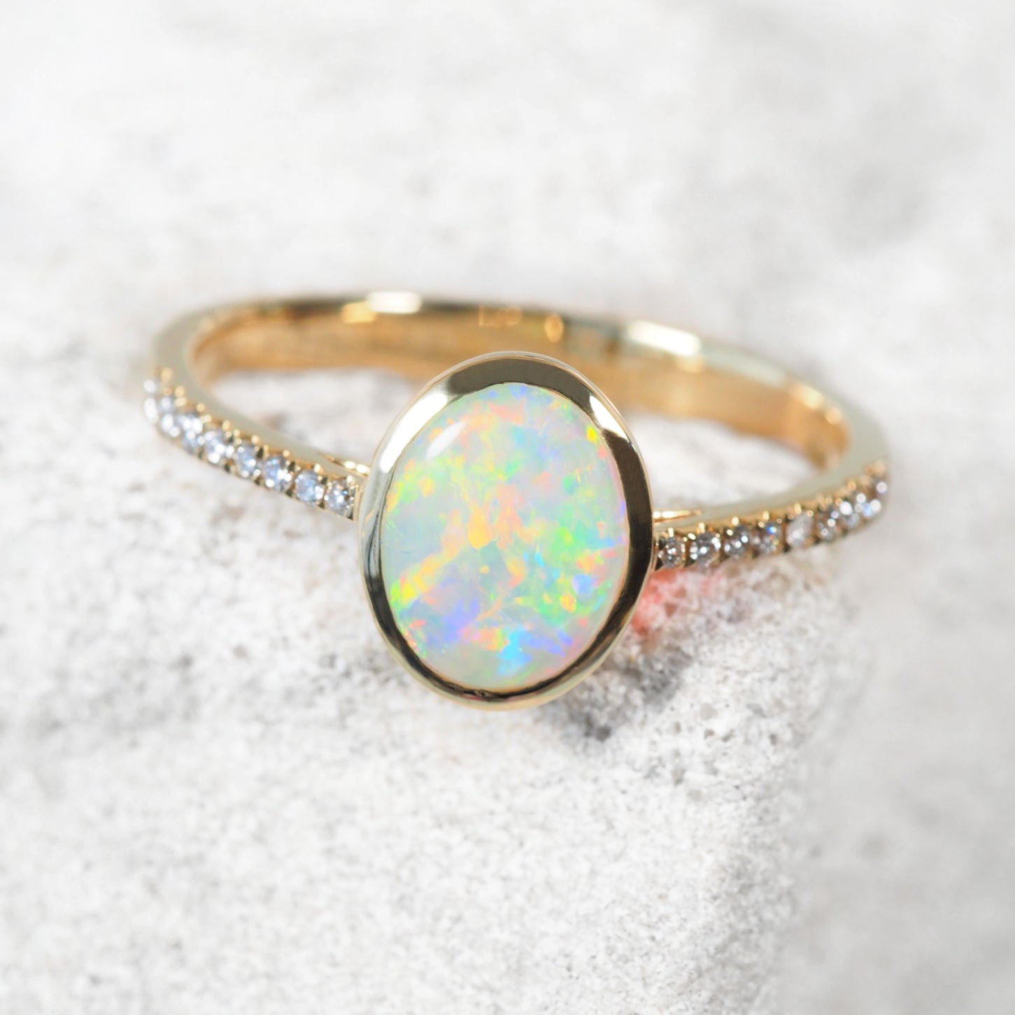 'Camile' opal and diamond ring in 14ct yellow gold with bezel-set oval Coober Pedy crystal opal and 16 shoulder-set white diamonds