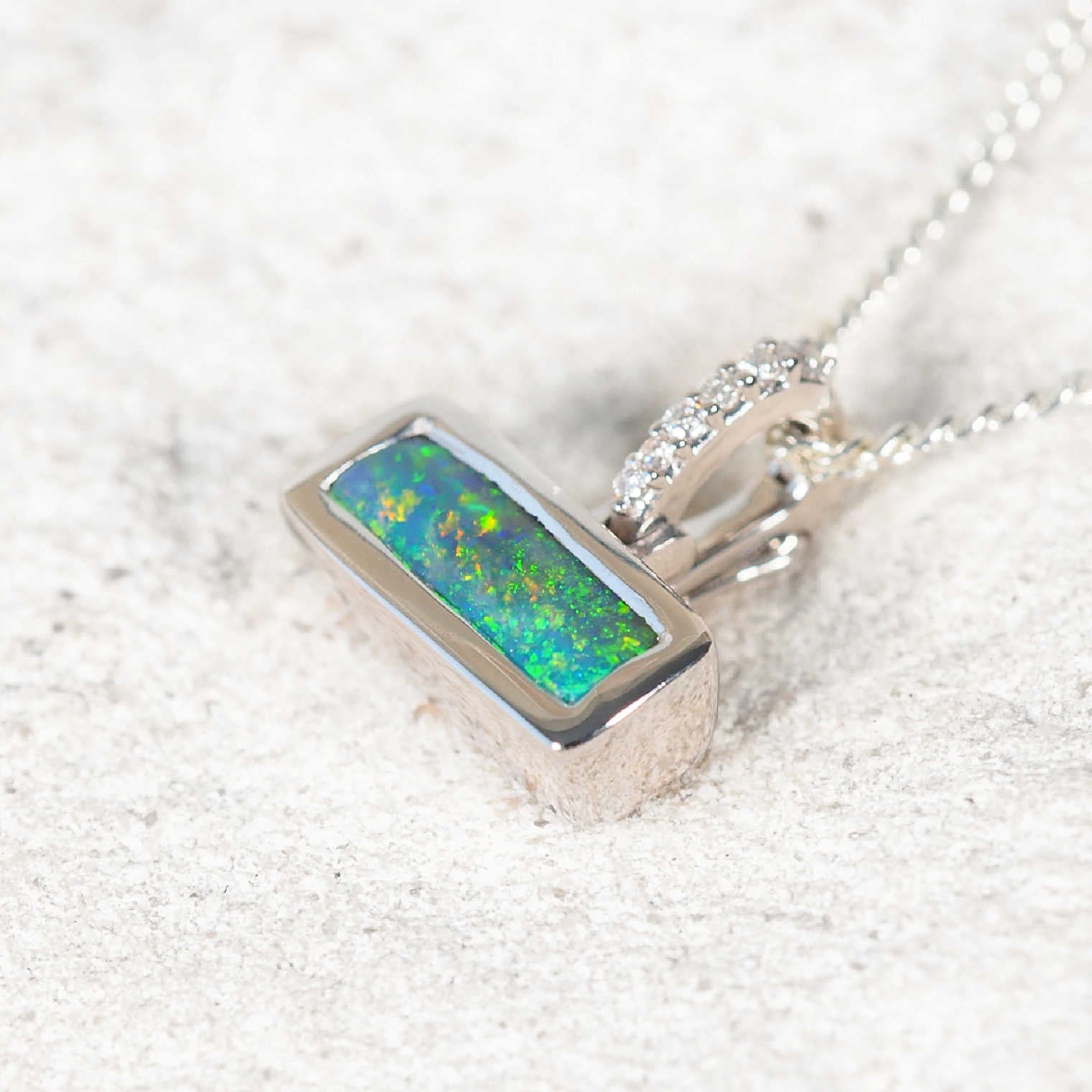 Petite Australian black opal pendant with bezel-set Lightning Ridge opal and six white diamonds – ‘Cassidy’ by Black Star Opal