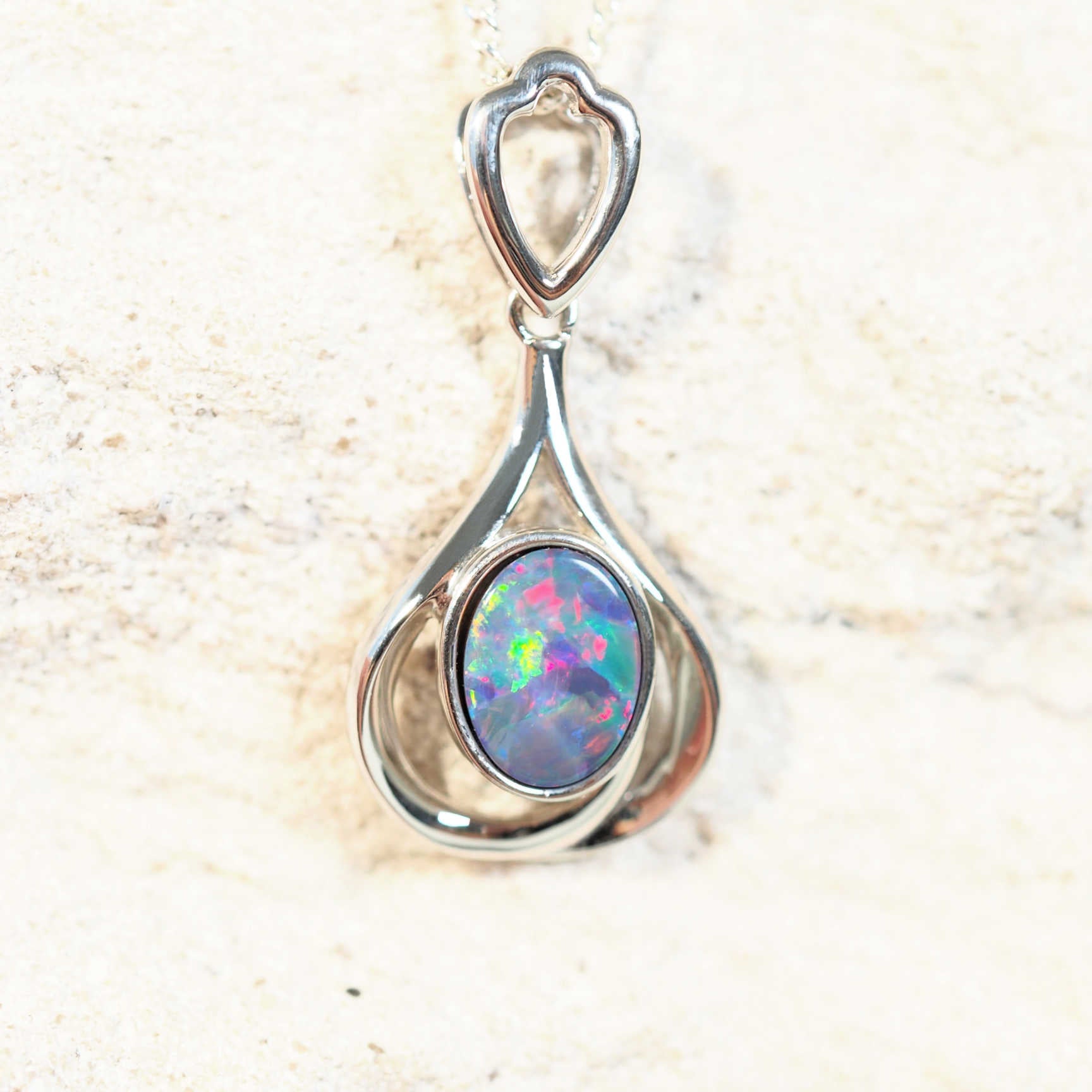 colourful oval opal pendant in silver
