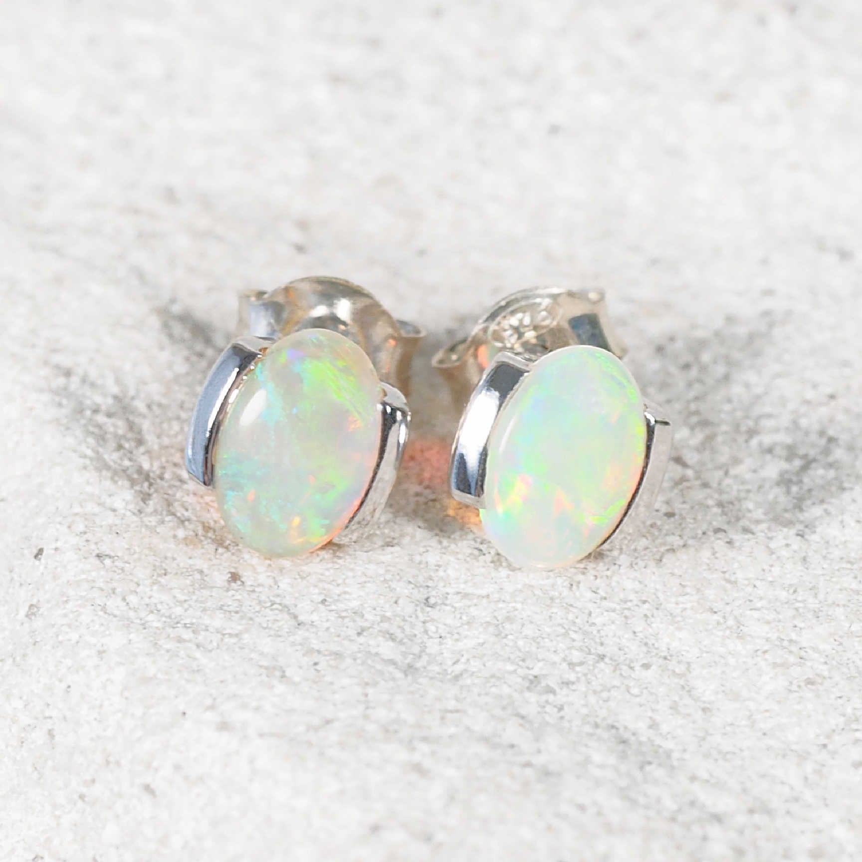 Cimilia opal stud earrings in 14ct white gold with oval green-flashing Australian opals