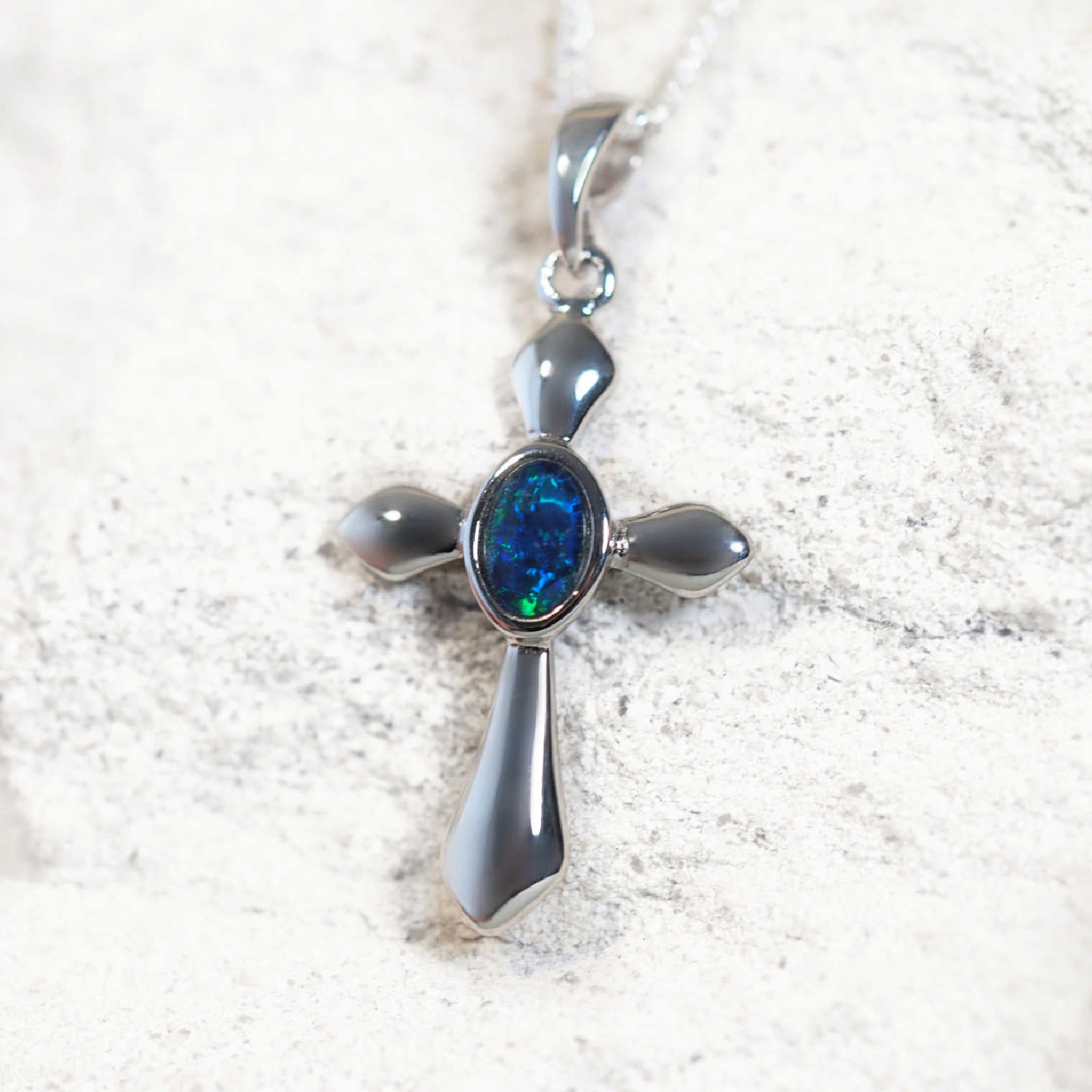 'Crucifix Blue' opal pendant in sterling silver with bezel-set oval Australian triplet opal in vivid blue and green tones