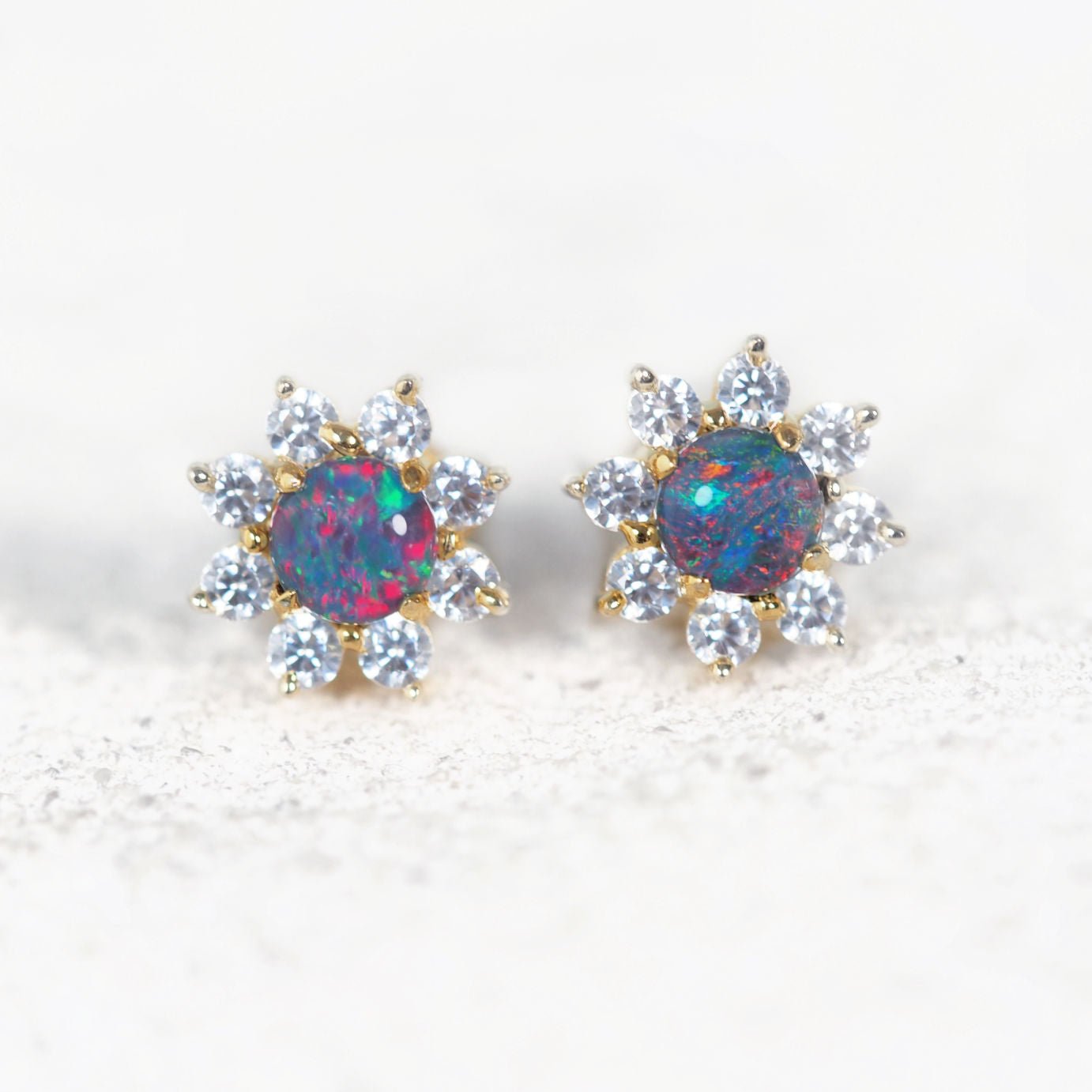 Gold plated silver opal stud earrings with round multi-coloured triplet opals and crystal flower halo.