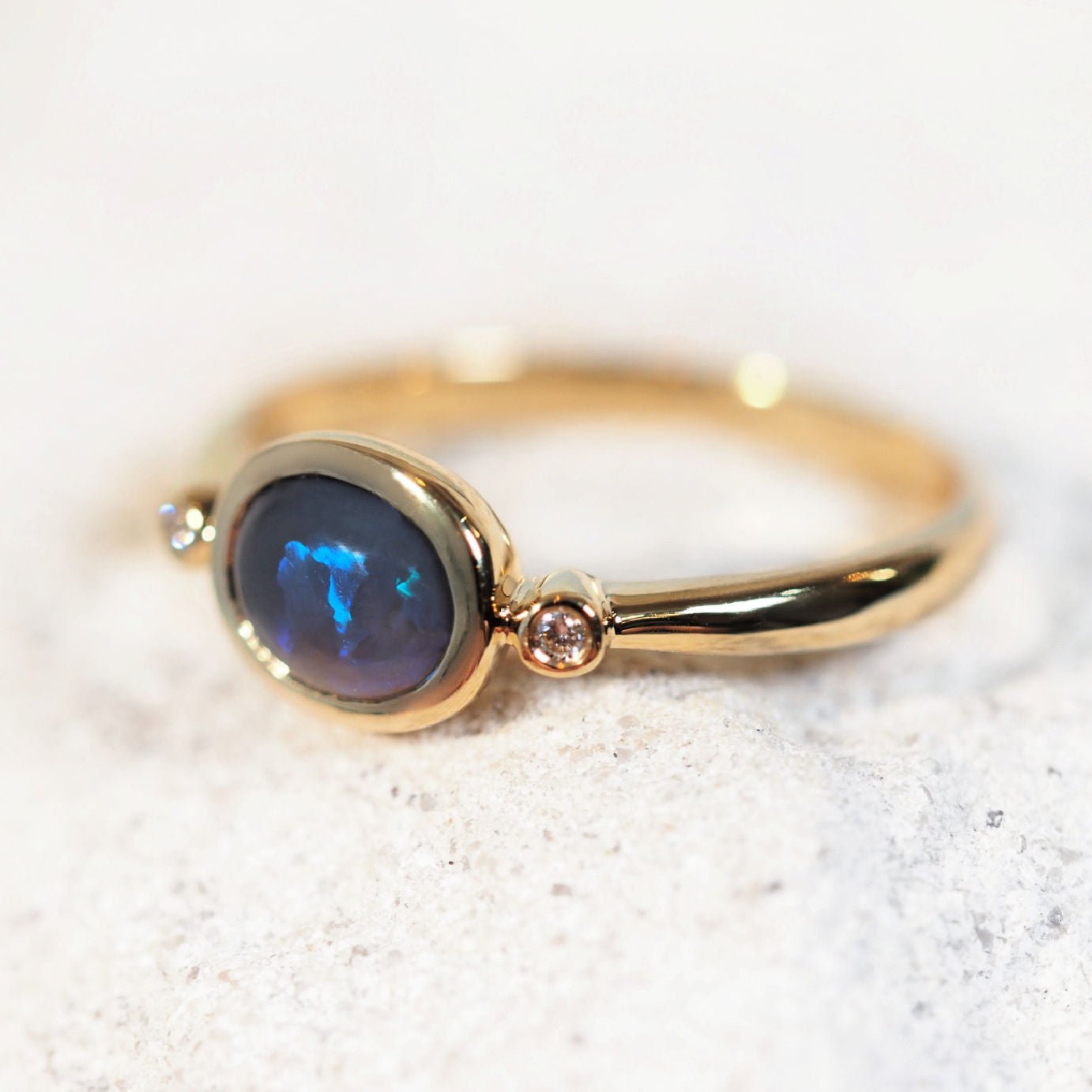 'Cyane' opal ring in 14ct yellow gold with side bezel-set Lightning Ridge black crystal opal and two accent diamonds