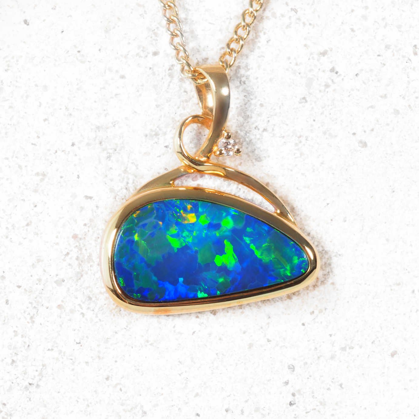 Freeform-shaped opal and diamond necklace set in polished gold