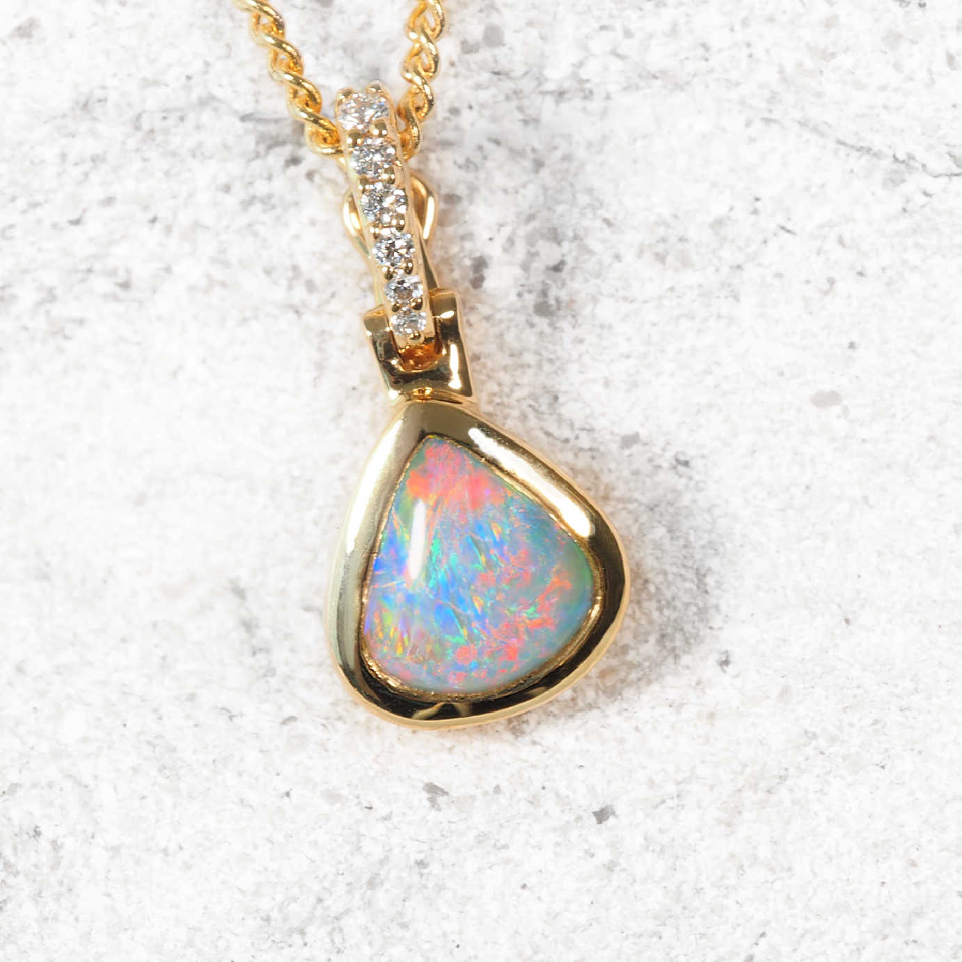 Darya Lightning Ridge teardrop opal pendant in 18ct yellow gold with diamond enhancer