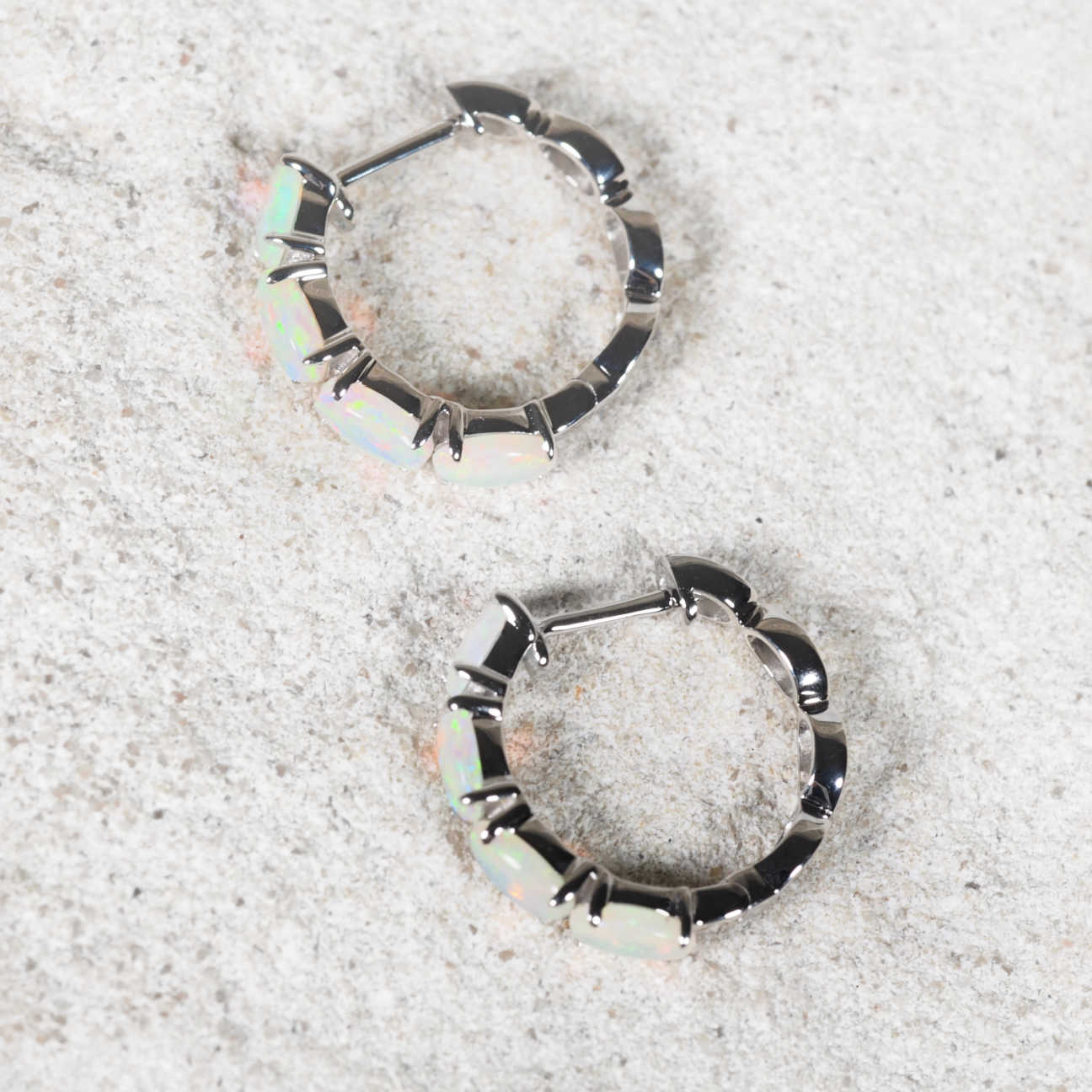 Polished white gold opal hoop earrings with colourful Australian crystal opals