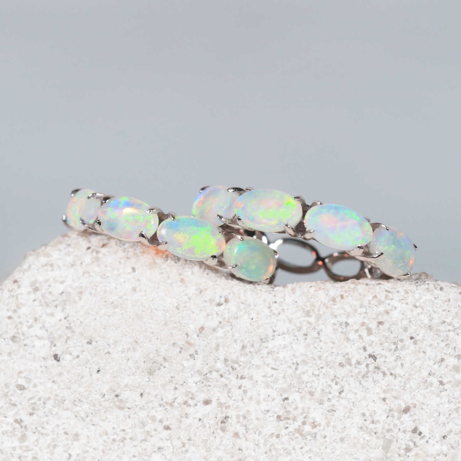 Elegant Delphine earrings showcasing four oval-shaped Coober Pedy crystal opals per hoop