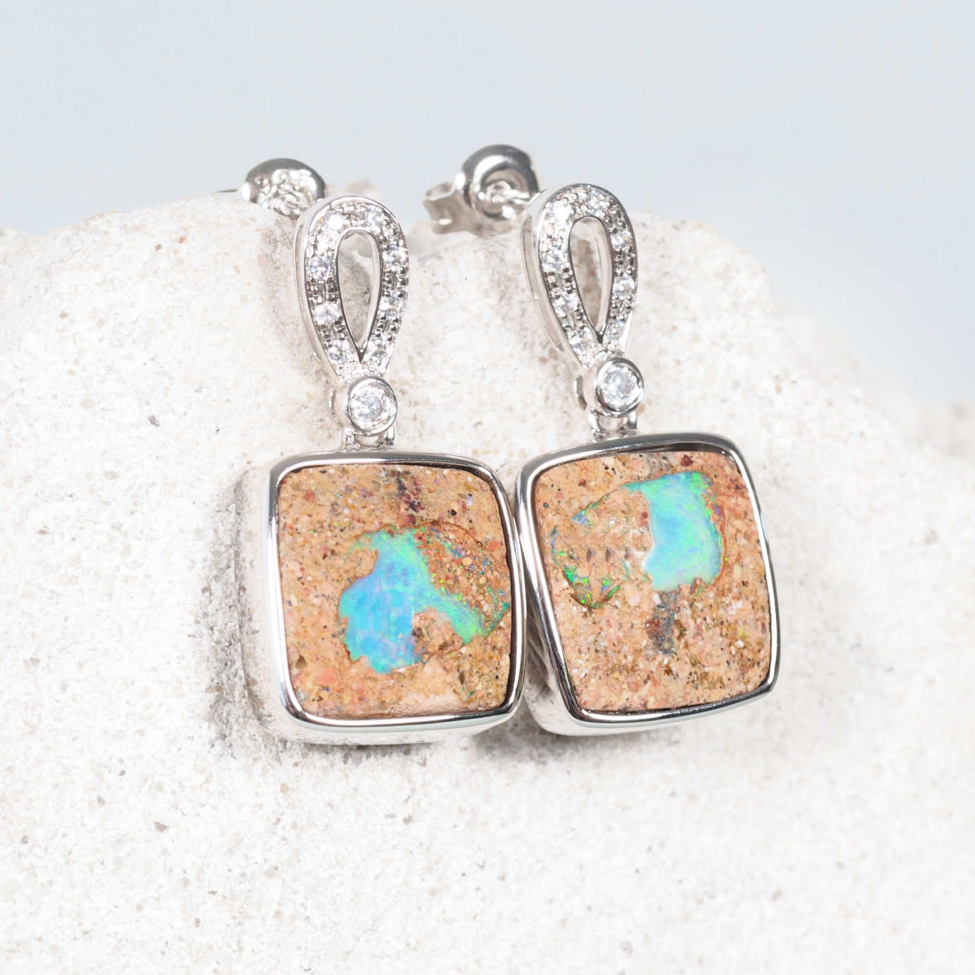 boulder opal earrings set in sterling silver with white sapphires