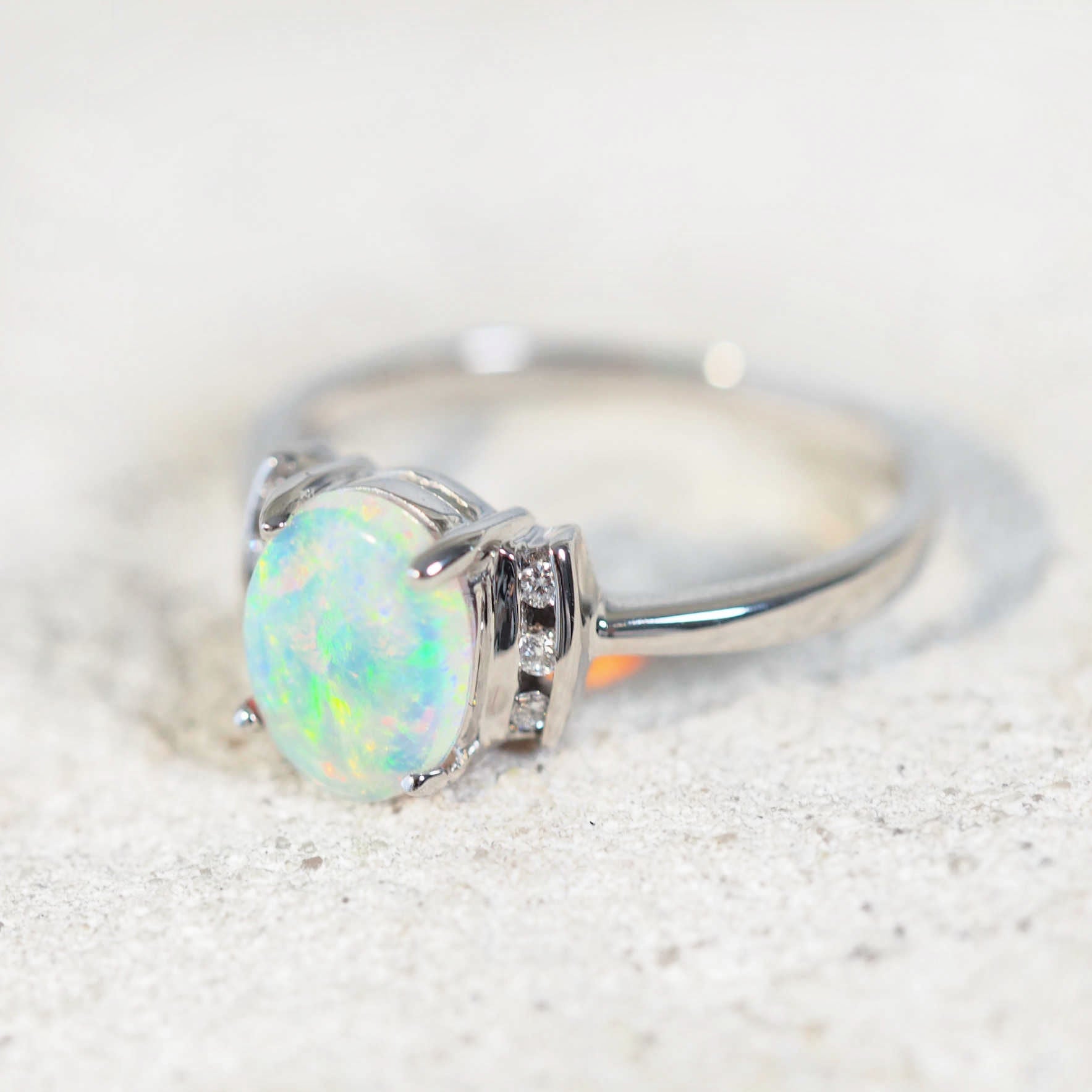 green crystal opal ring set into white gold with diamonds