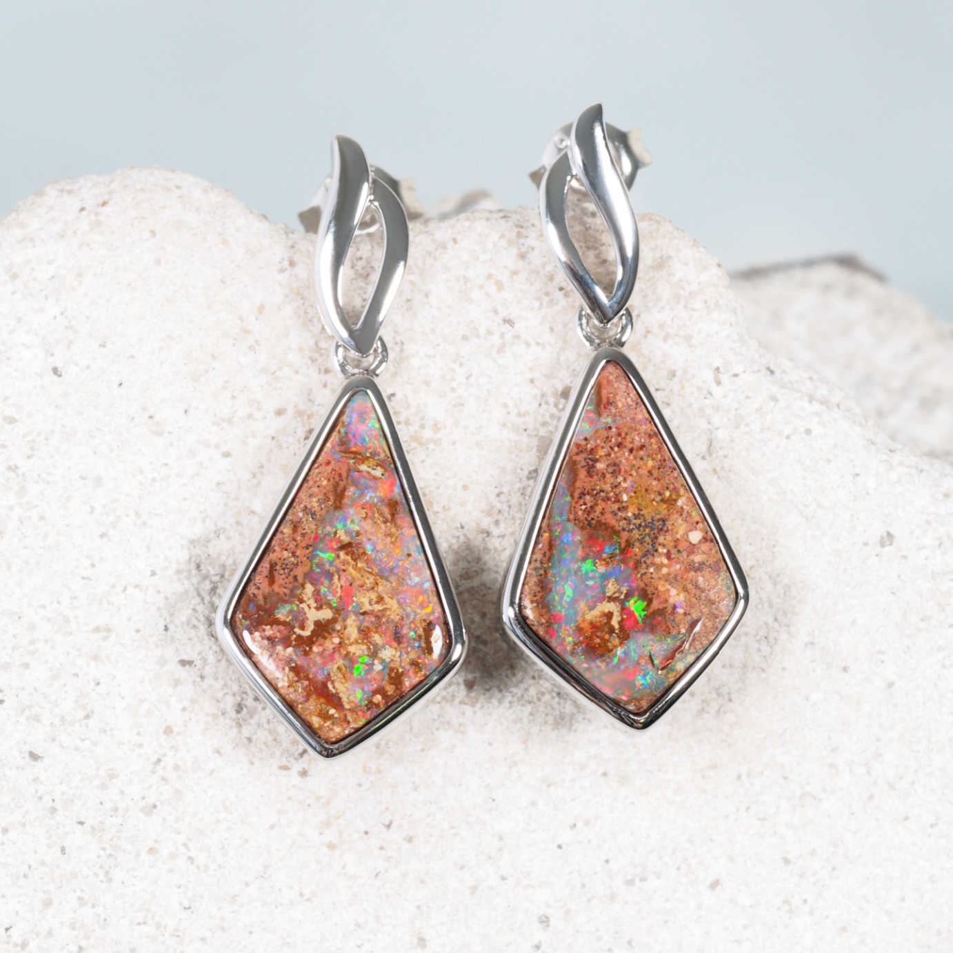 Opal earrings featuring kite-shaped boulder opals with multi-colour fire in sterling silver