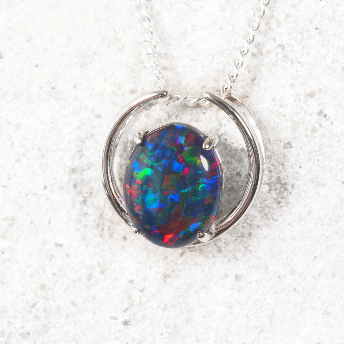Modern silver opal necklace with vibrant oval Australian triplet opal in an open circle design