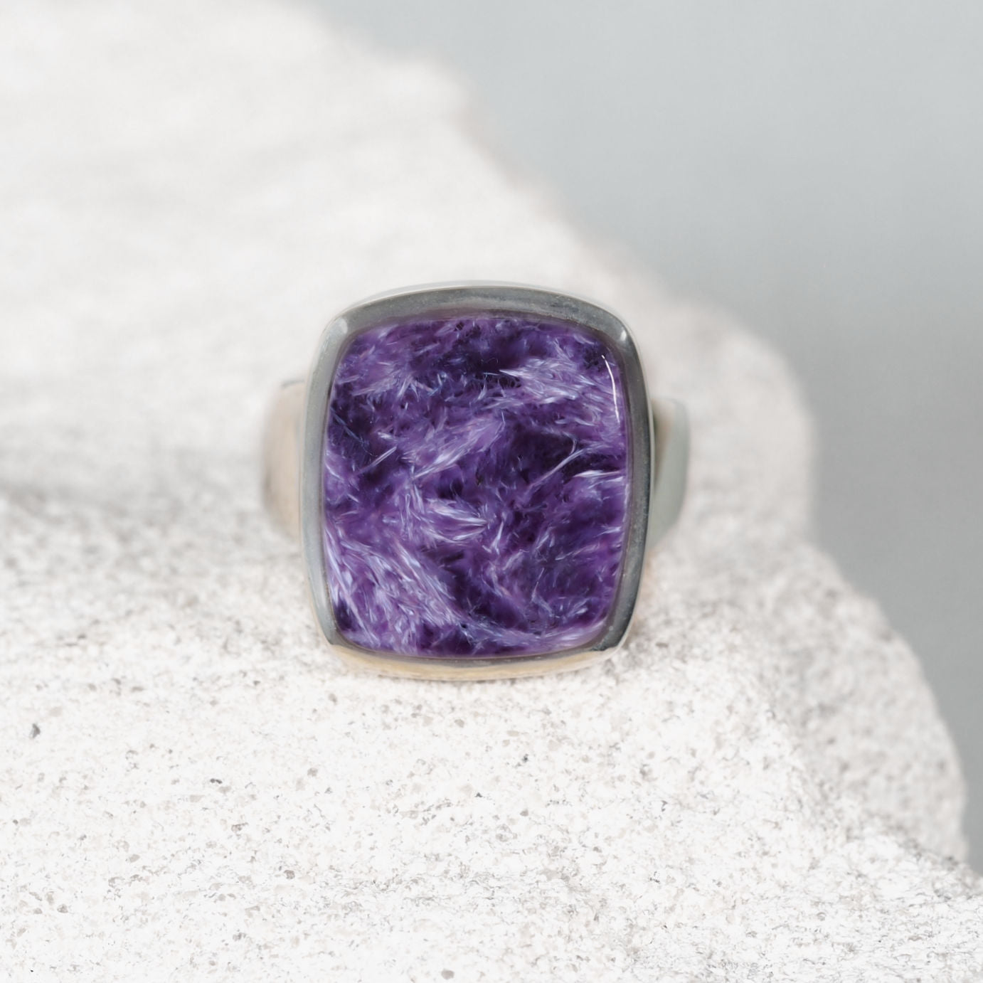 Charoite silver ring displaying purple hues with white marbling through the gemstone