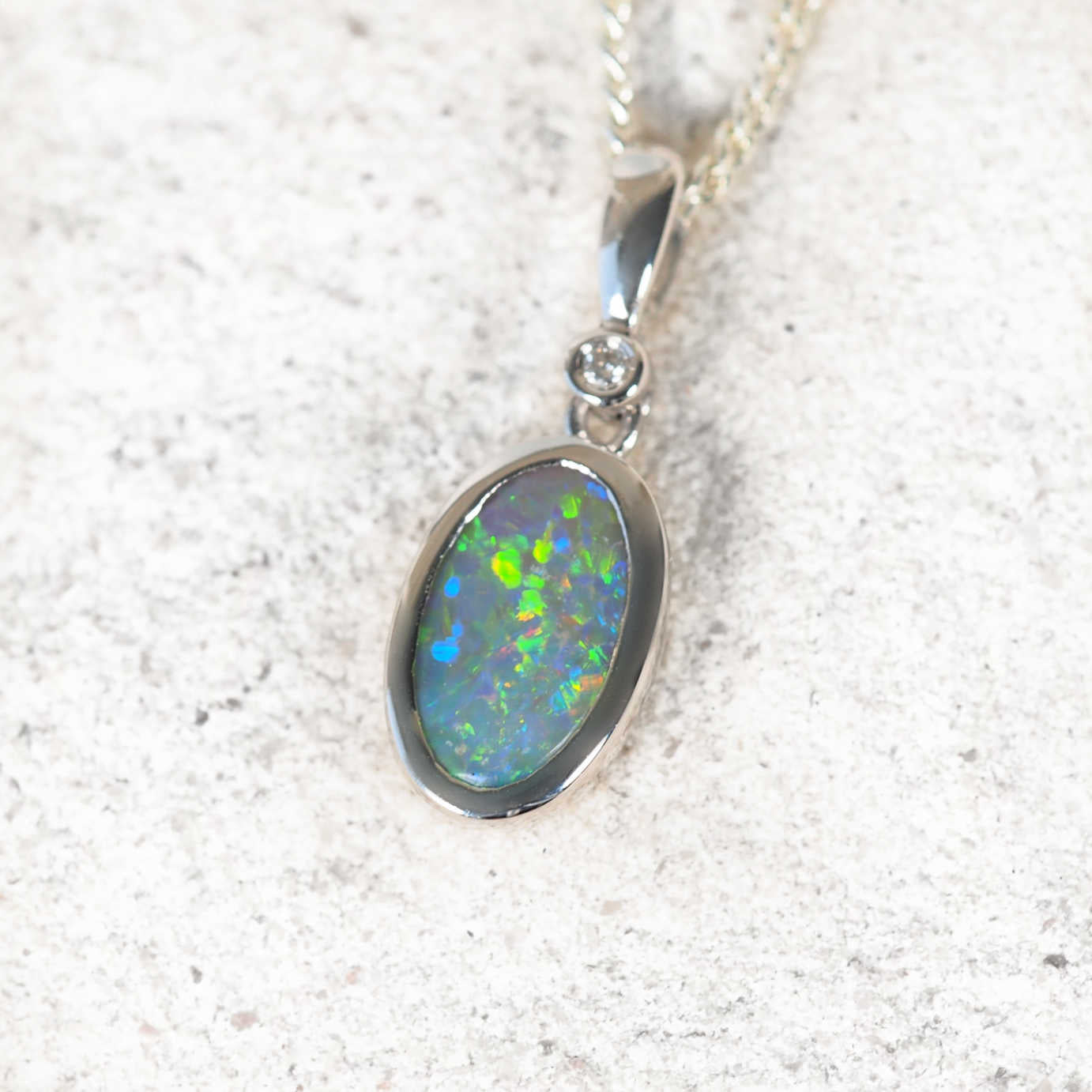 Handcrafted Elyra pendant with Australian black opal and sparkling diamond in refined 14ct white gold setting