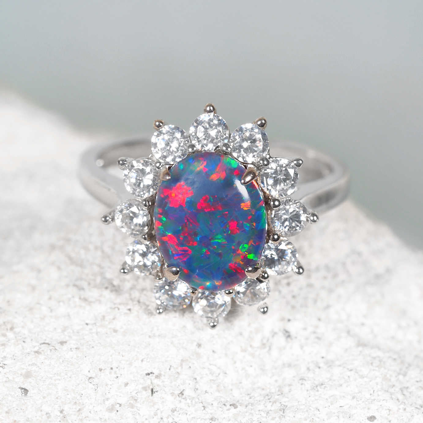 Silver opal ring with a halo of diamantes