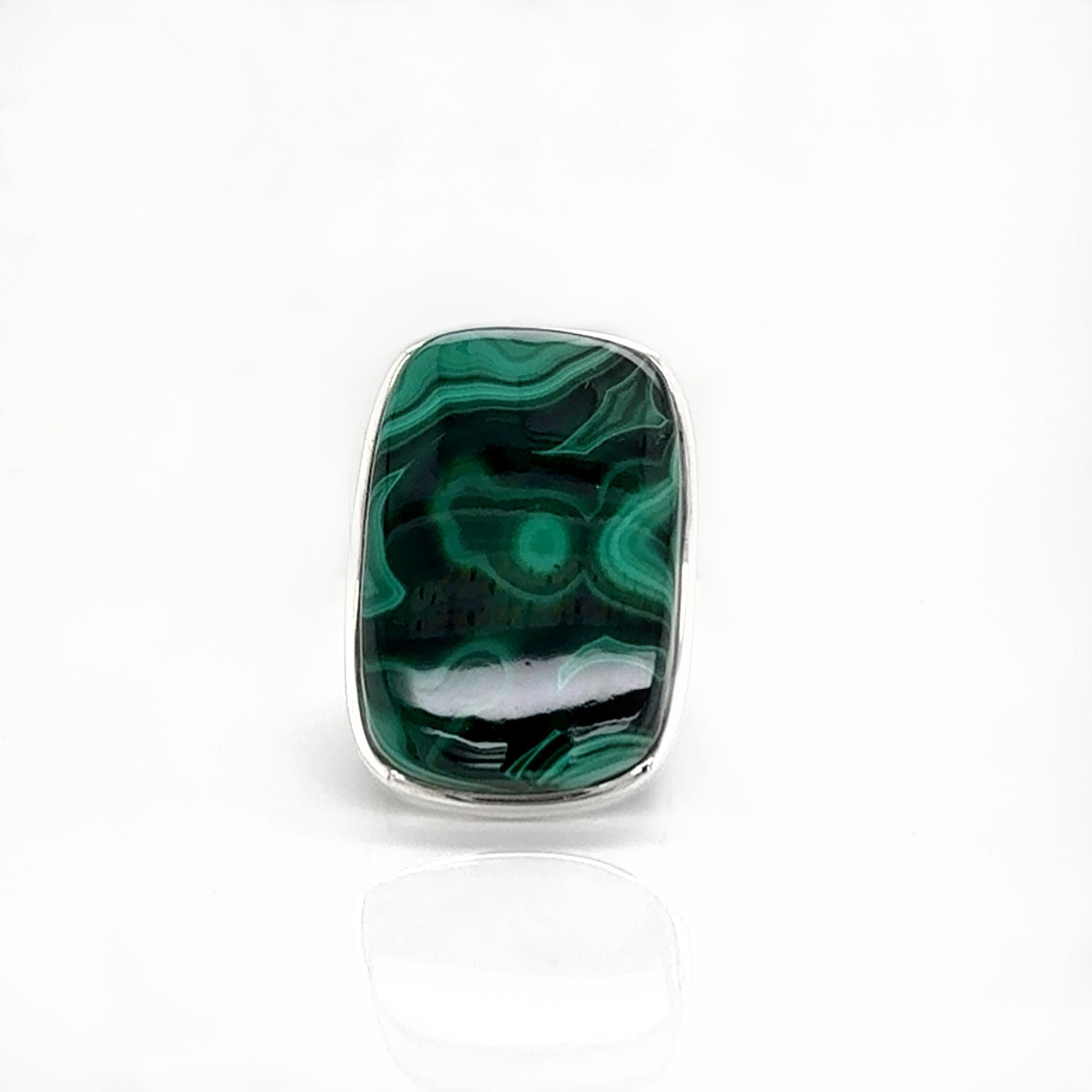 Green malachite stone with silver setting on a white background