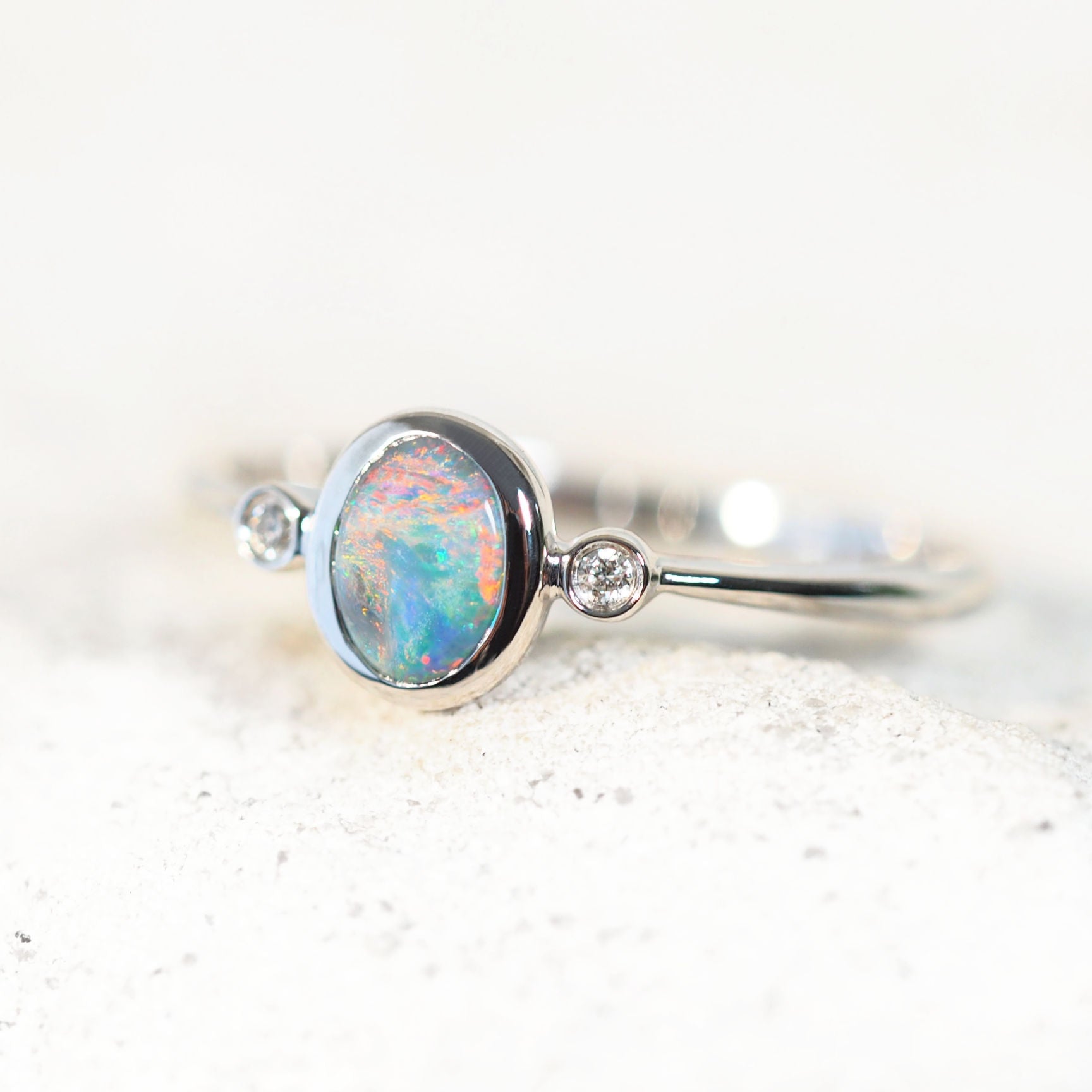 semi-black opal ring set in white gold with diamonds