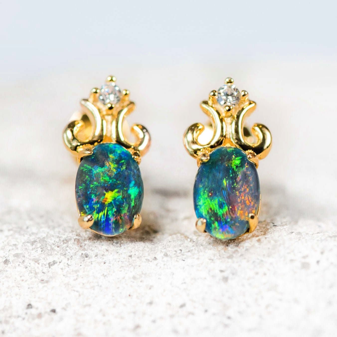 opal stud earrings with an intricate design and diamantes