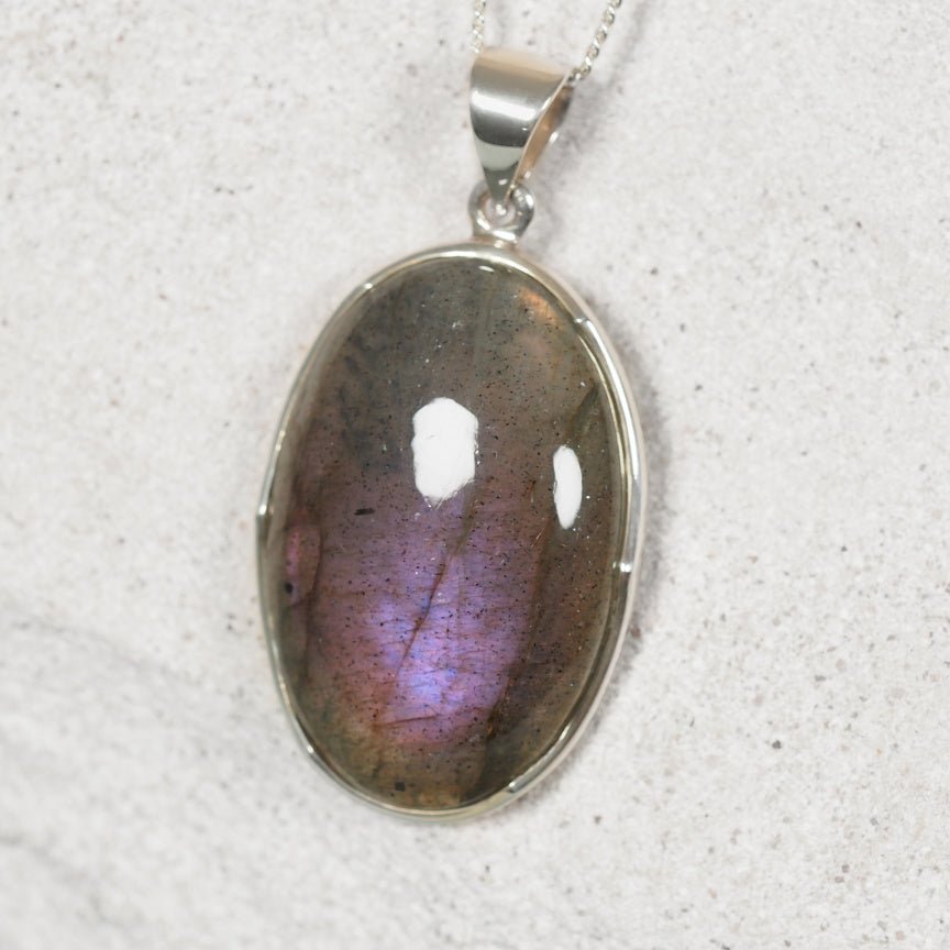 Close up of Labradorite silver pendant displaying mild purple hues