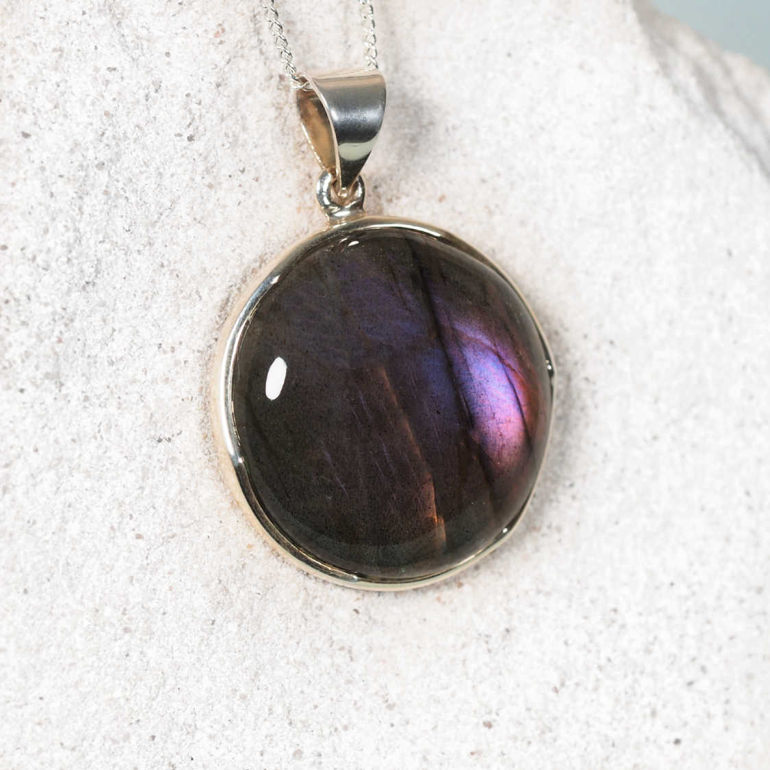 Labradorite Pendant displaying flashes of pink and purple with a hint of blue