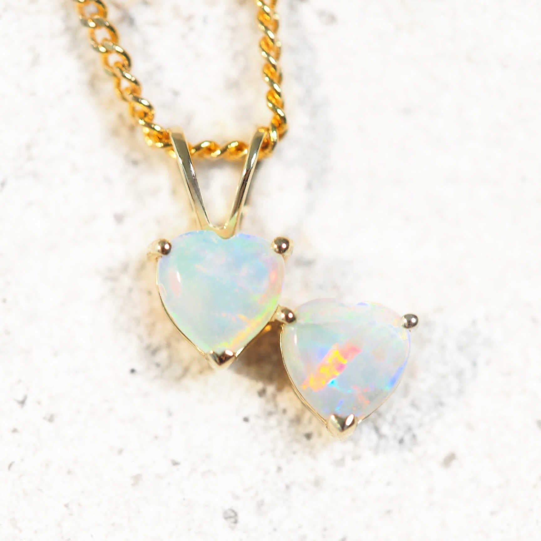 Gold pendant with two heart-shaped Australian opals on chain