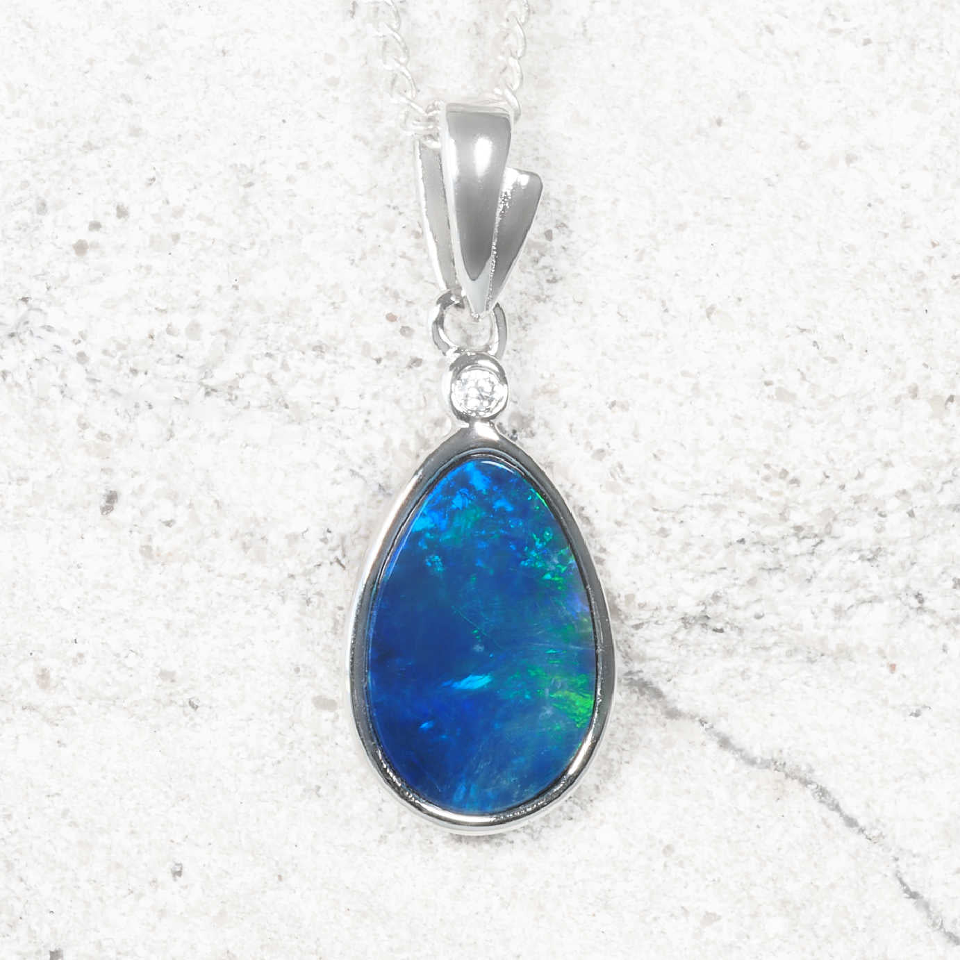 Sterling silver Australian opal pendant featuring a teardrop opal doublet with vibrant blue and green flashes