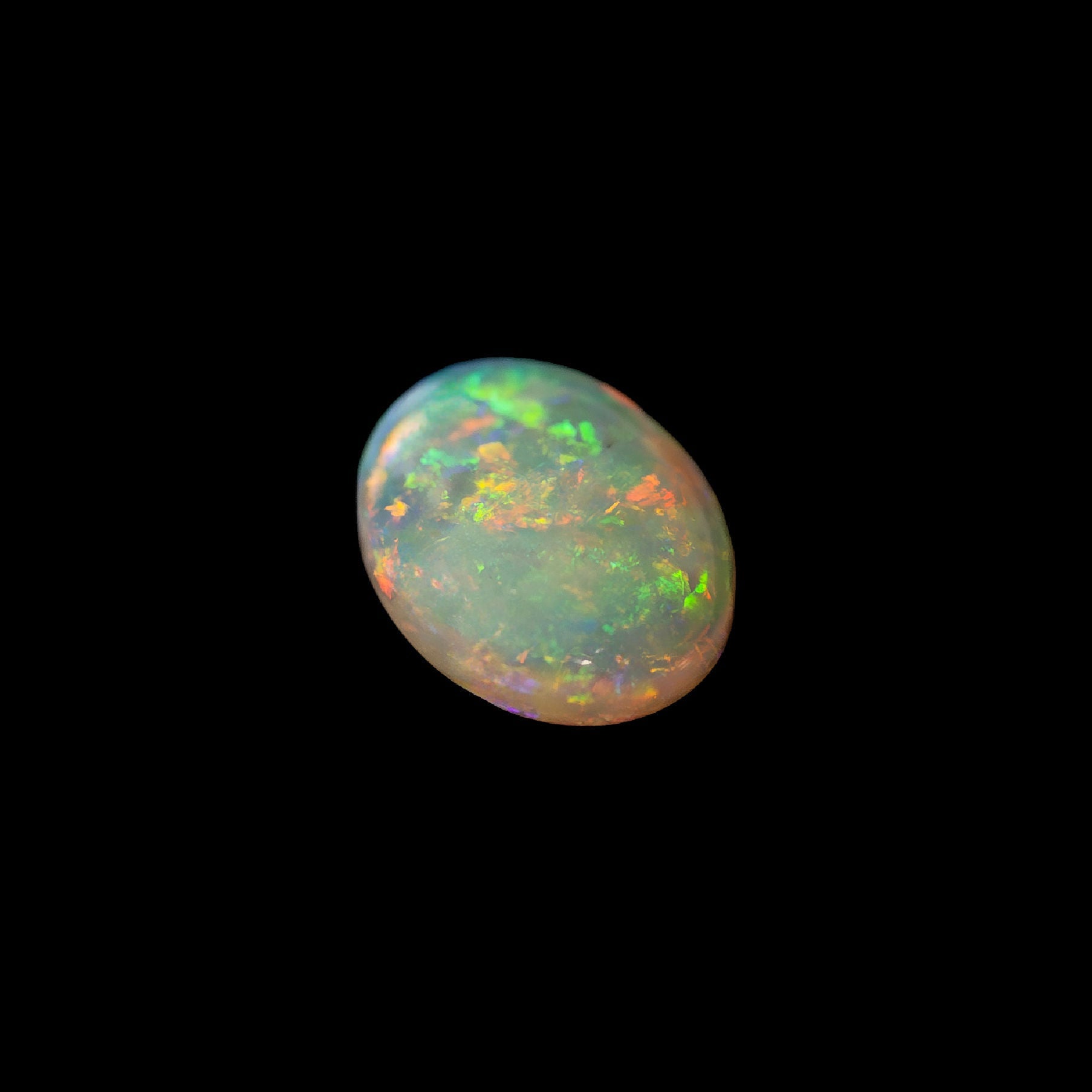 Australian multi-colored crystal opal gemstone on a black background