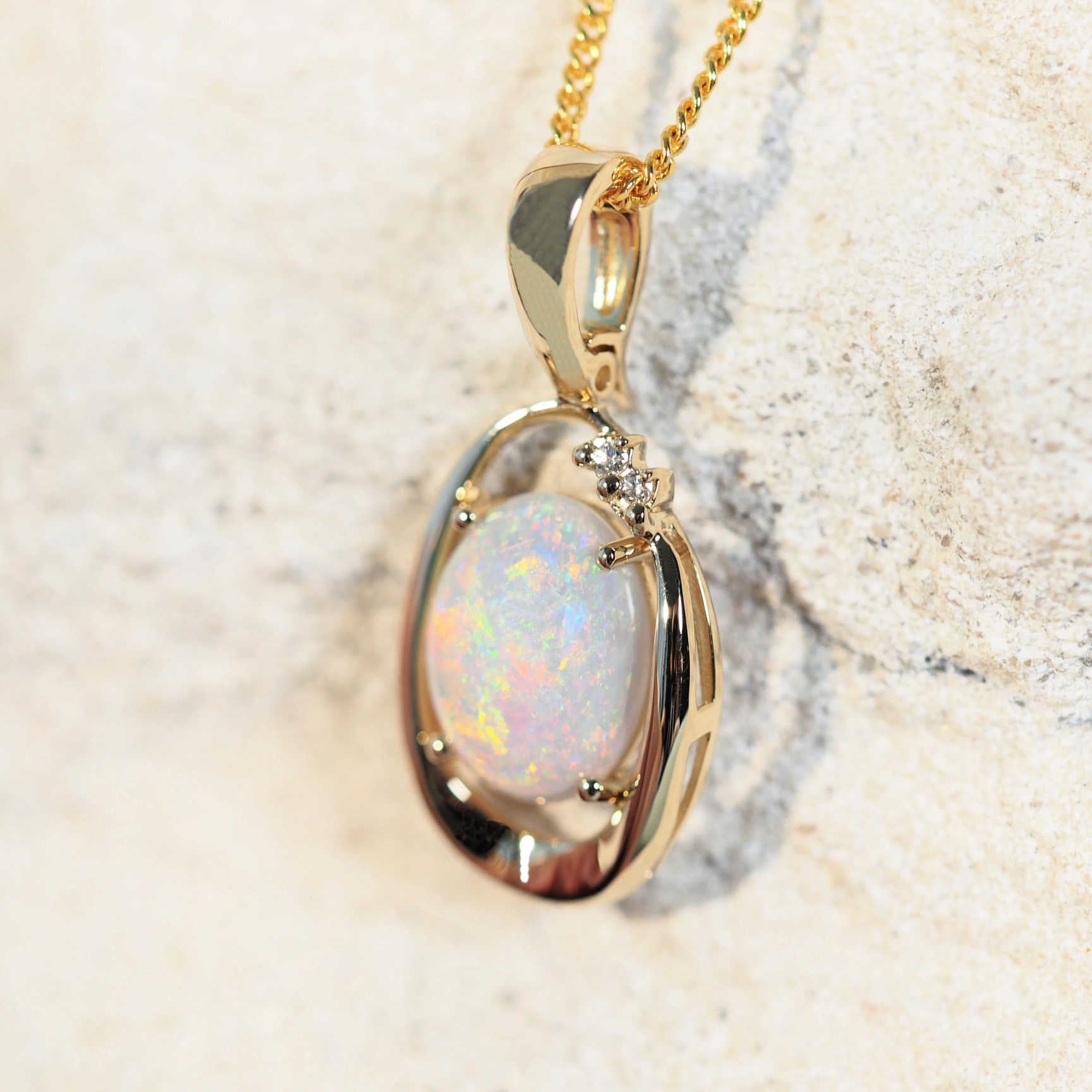 colourful white opal pendant with diamonds