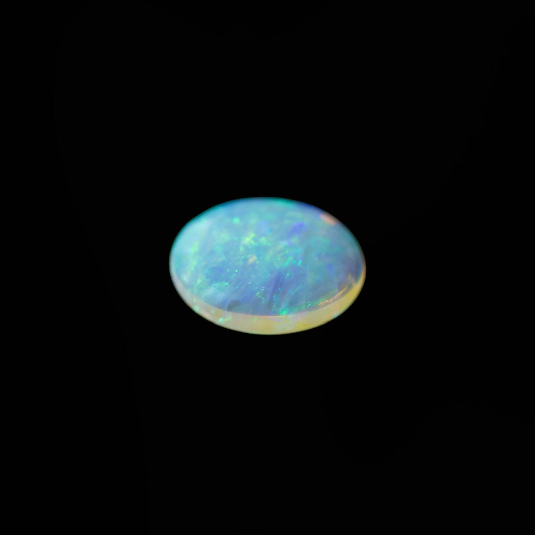 Opal gemstone on a black background