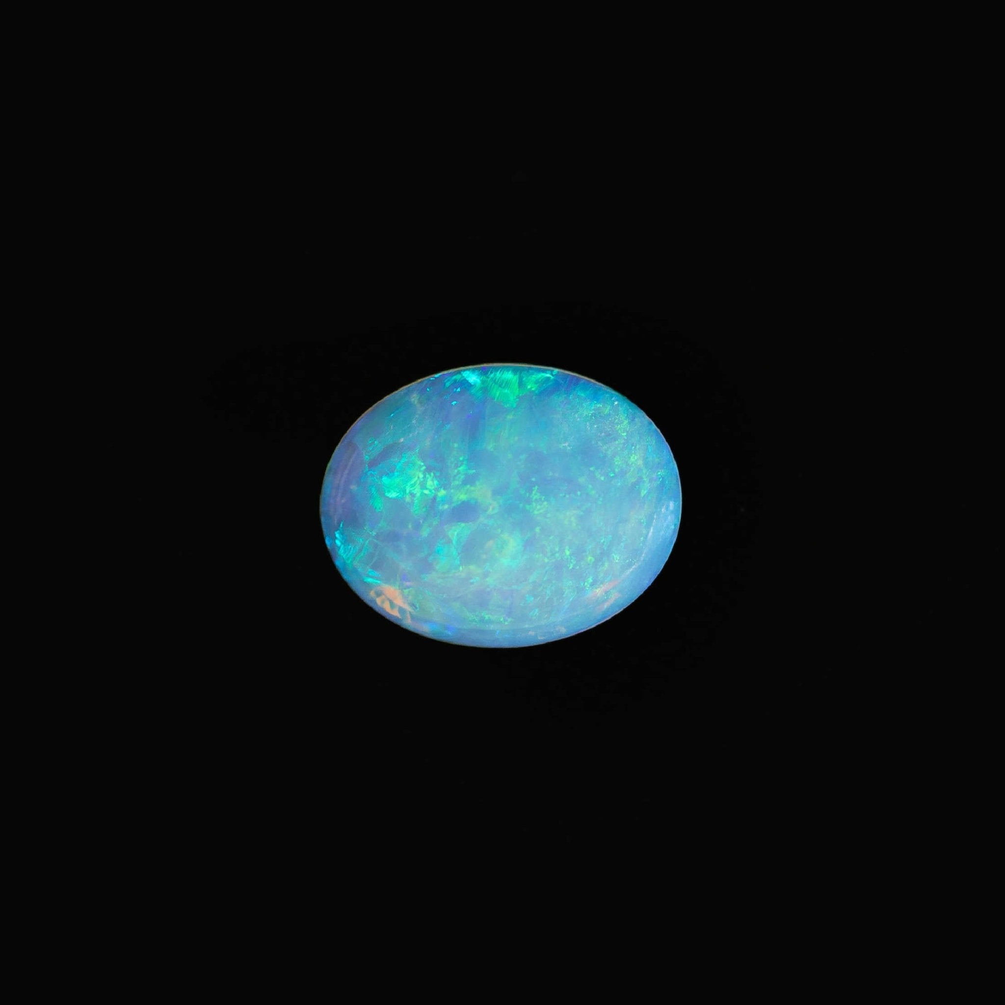 Australian opal stone with multicolored patterns on a black background