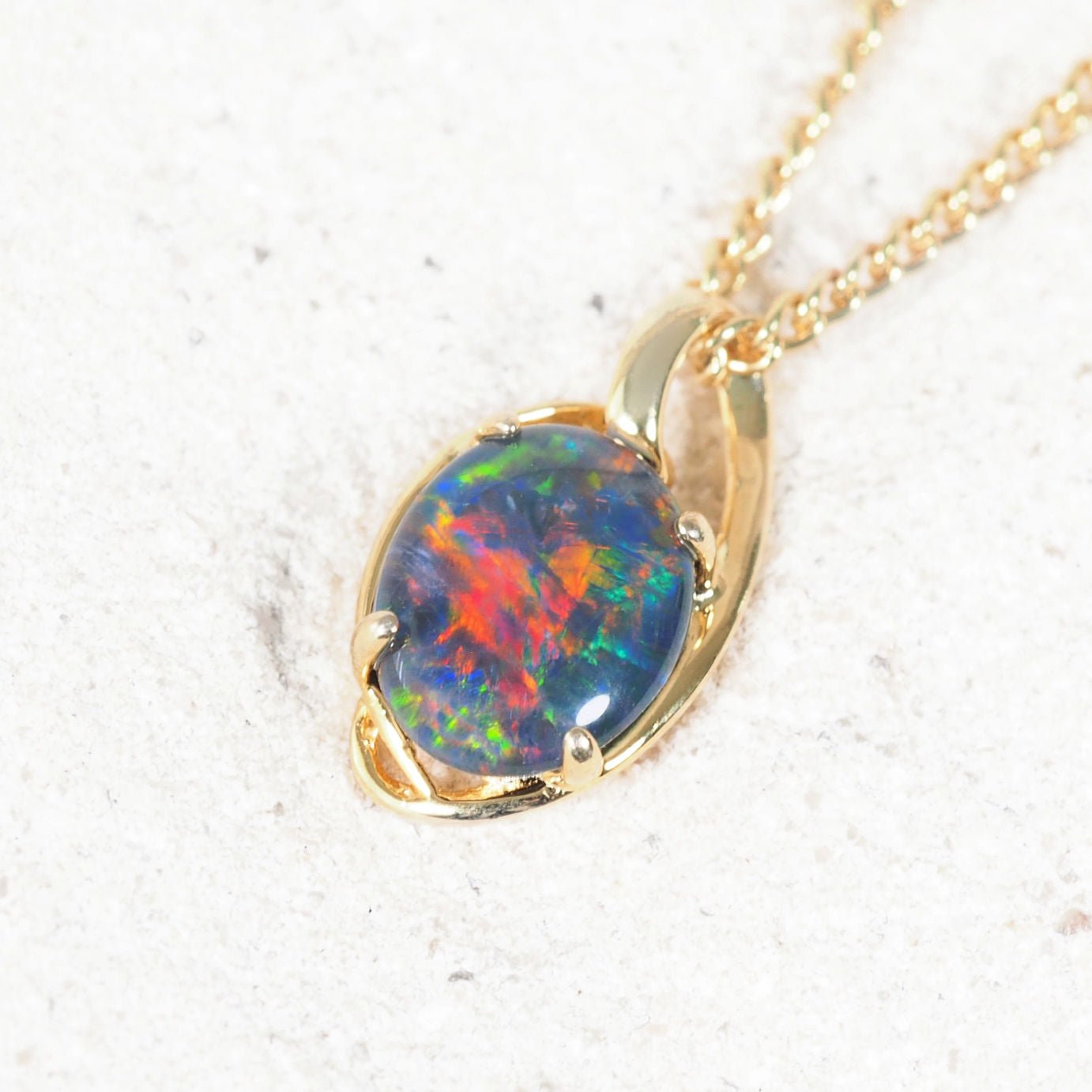 Luxurious gold-plated silver necklace pendant featuring oval-shaped Australian triplet opal with shimmering multi-colour flashes