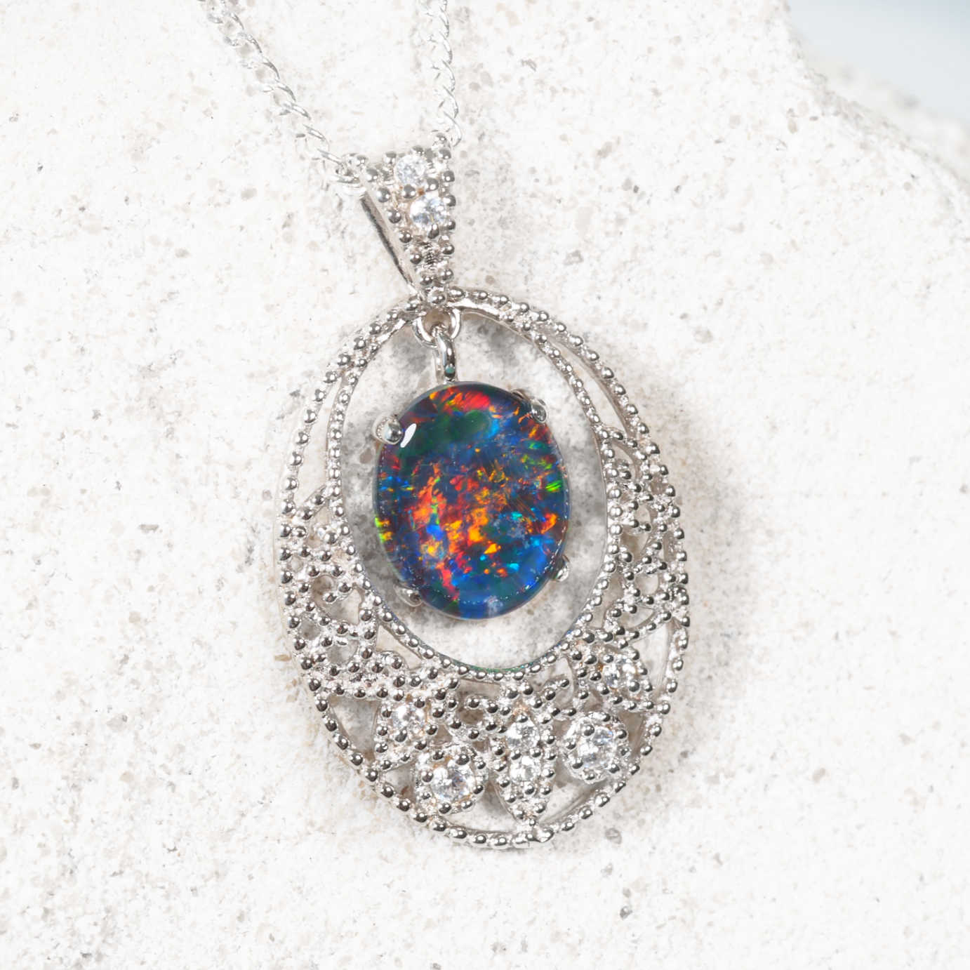 Sterling silver lace design opal pendant with oval Australian triplet opal and eight cubic zirconias