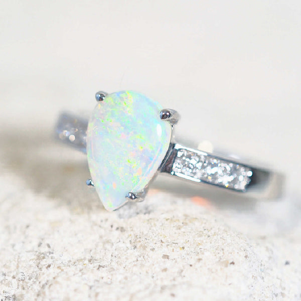 opal engagement ring set with a crystal opal and six diamonds along the band