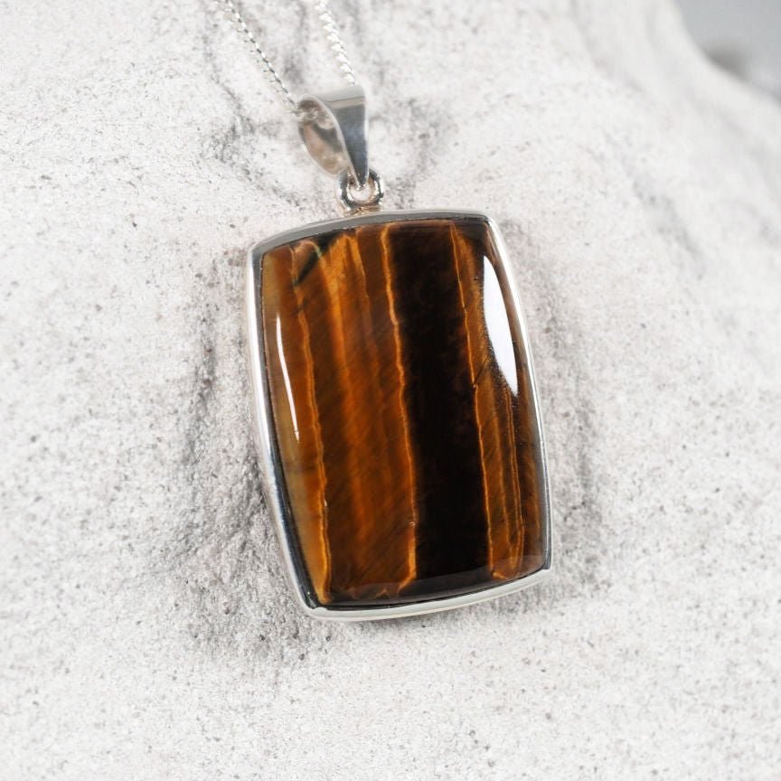 Square Tiger’s Eye cabochon pendant set in sterling silver.