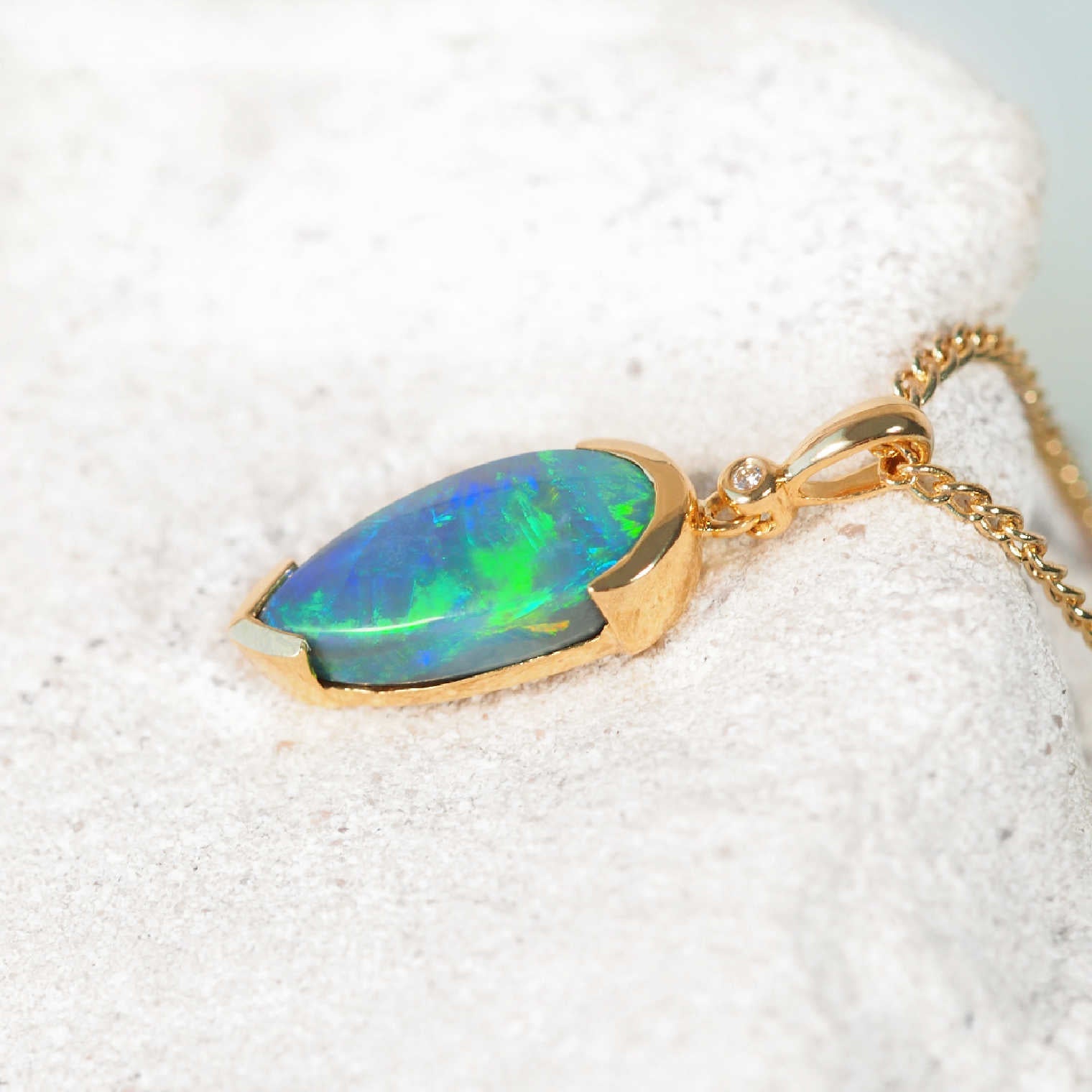 Australian Lightning Ridge black opal pendant in 18ct yellow gold with white diamond accent