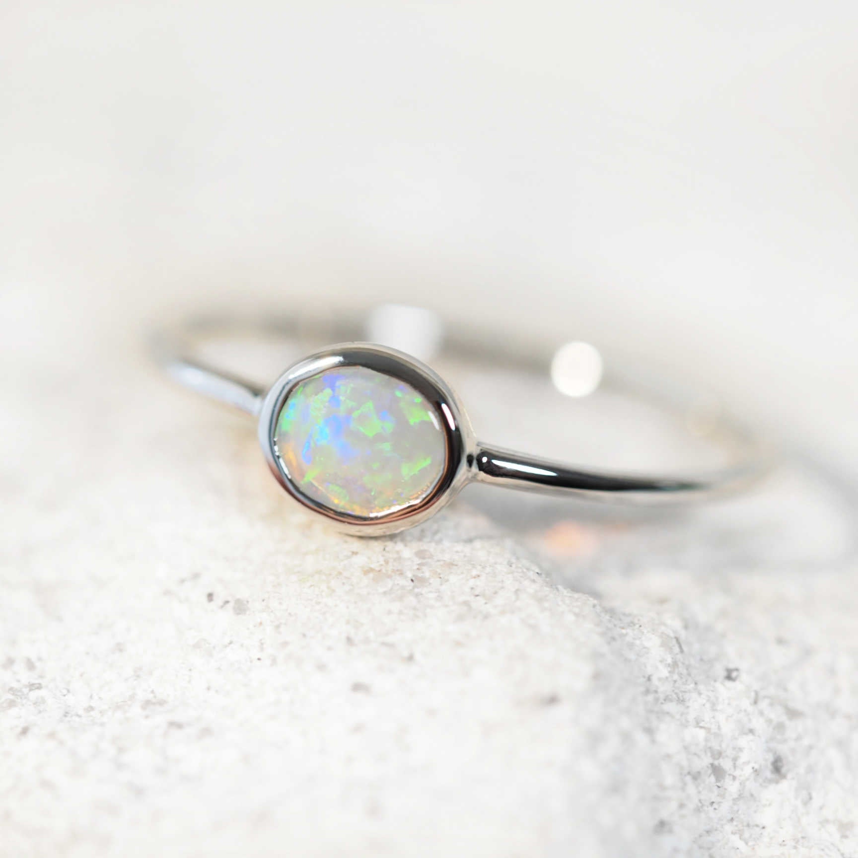 ‘Lorna’ opal ring in 14ct white gold with side-set oval green and blue crystal opal